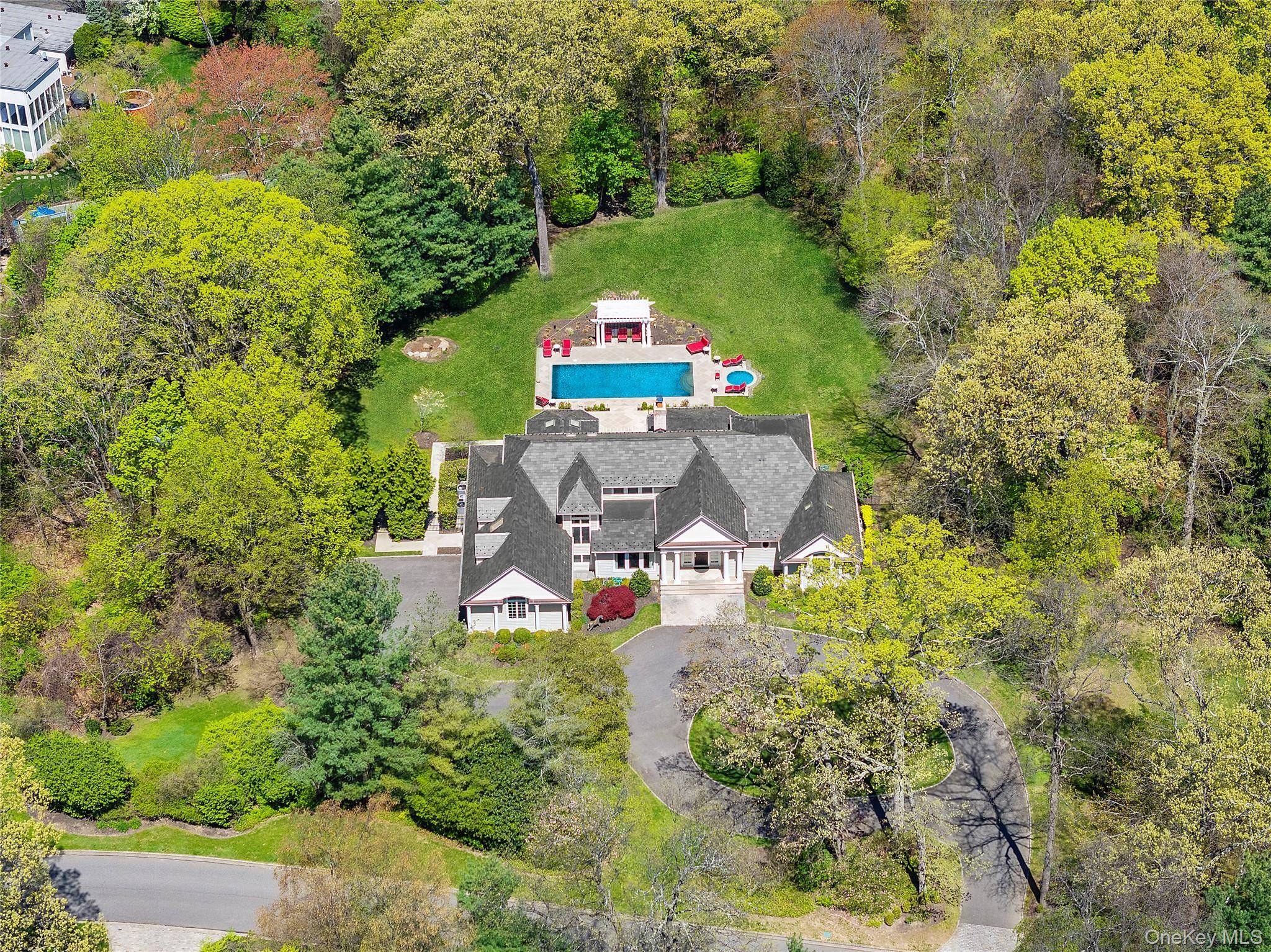 Welcome to 10 Evans Drive, an exquisite one of a kind estate nestled on a private street in the prestigious Broadhollow community of the incorporated Village of Brookville.