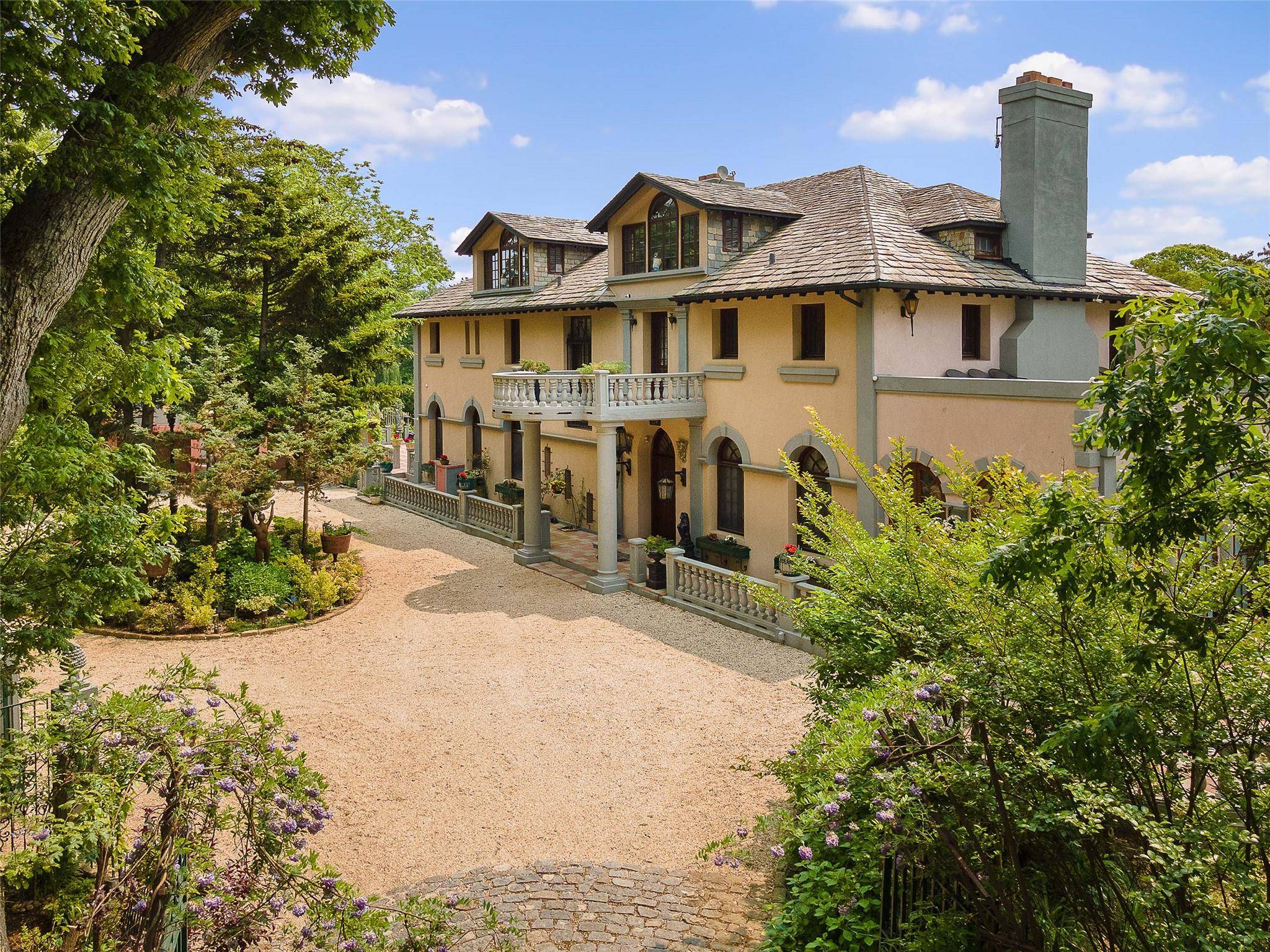 Welcome to 220 Woodside Dr, a spectacular Mediterranean style residence in Hewlett Bay Park.