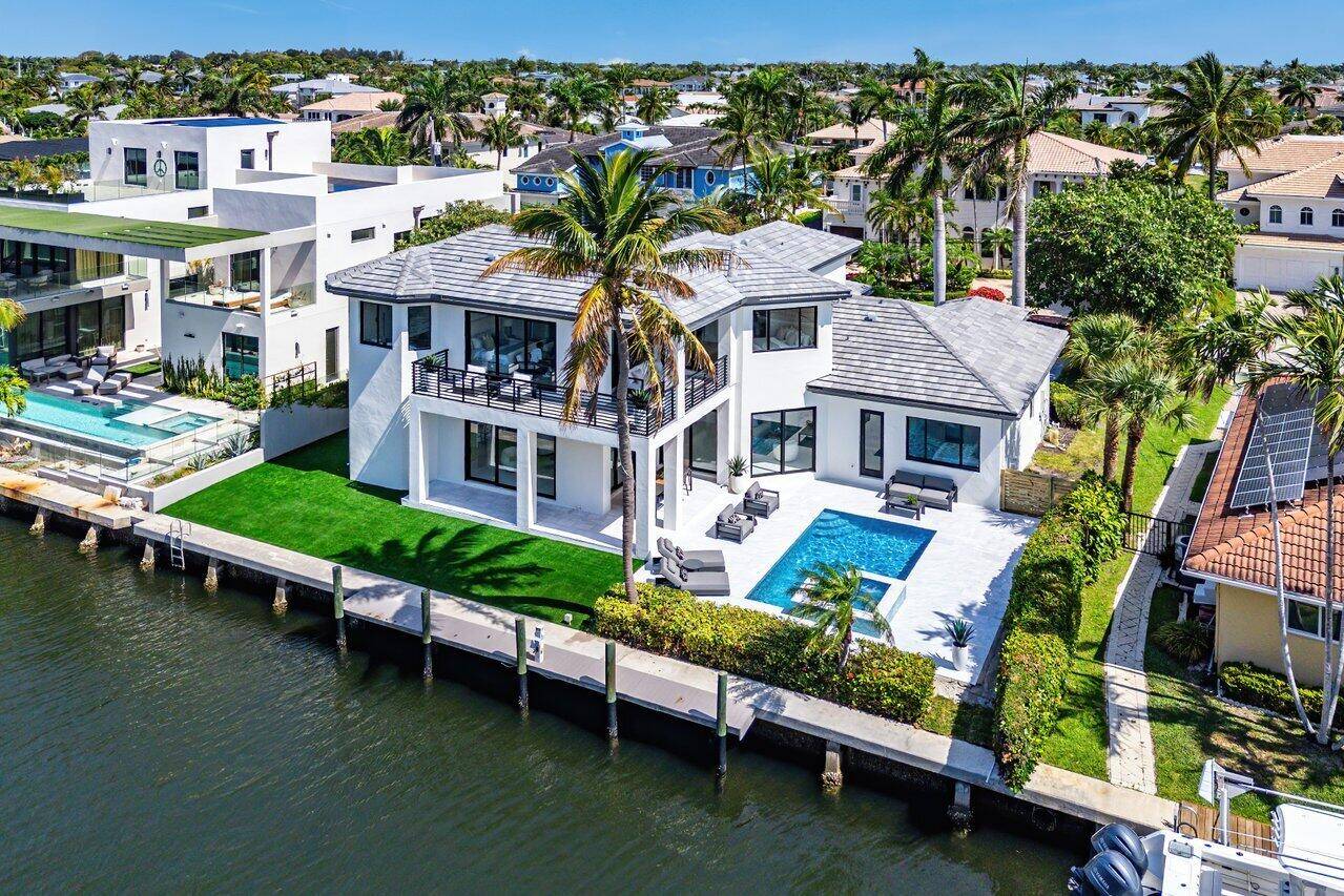 Welcome to this fully renovated waterfront home in East Boca Raton's highly sought after Boca Keys community.