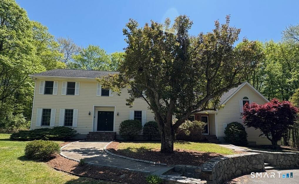 Serenity awaits in this classic colonial nestled on two level acres in a walker friendly cul de sac neighborhood.