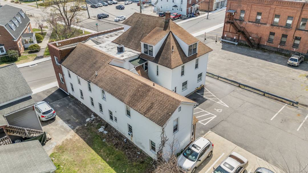 Unlock the potential of this solid 7 unit brick building, featuring a versatile mix of 5 residential apartments and 2 commercial office spaces.