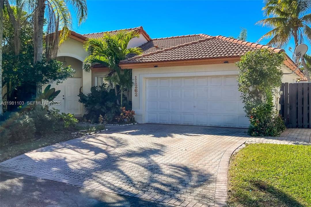 Beautiful one story, spacious single family home with a two car garage located in the prestigious resort style community of Doral Isles.