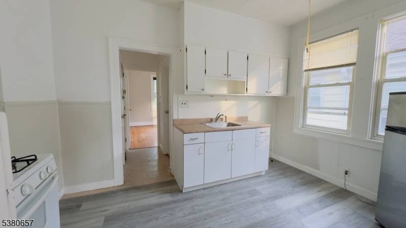 Well Maintained Four Family house, featuring 4 rooms in each apartment, two have two bedrooms eat in kitchen, bathroom and living room on the second floor.