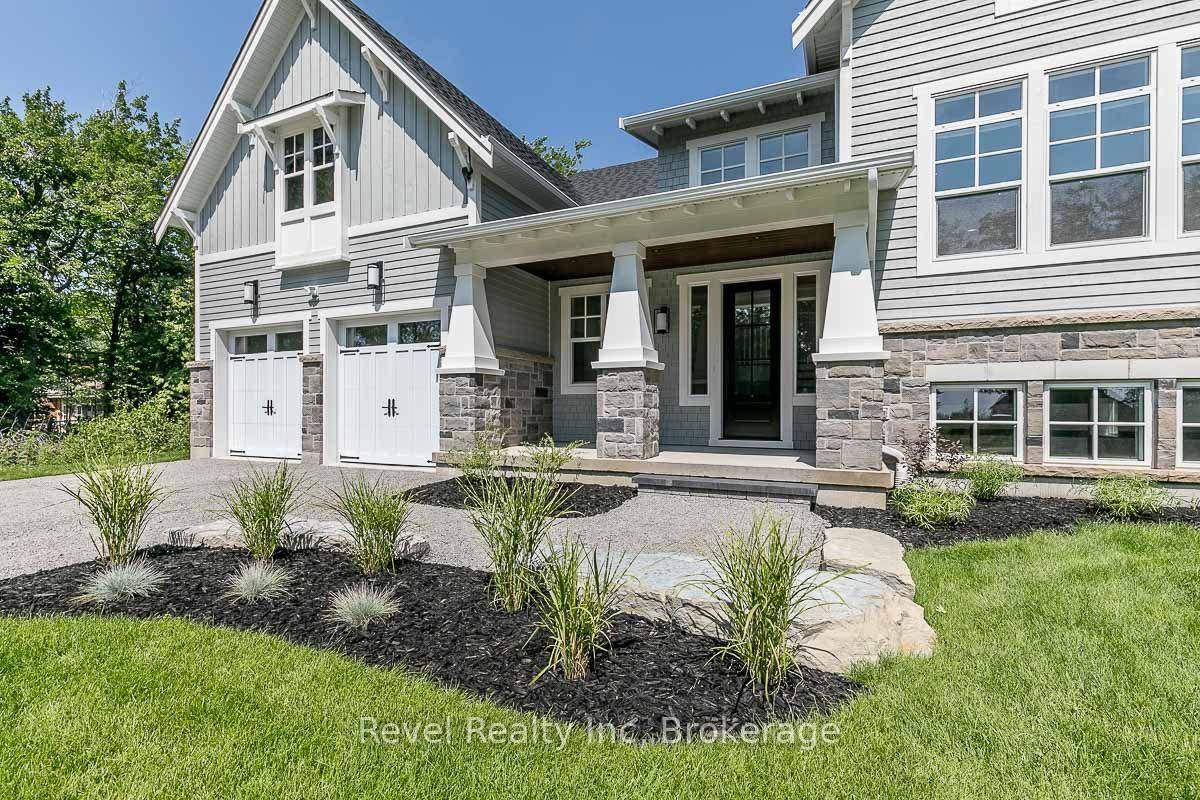 Indulge in the epitome of coastal elegance with this exquisite custom built craftsman style estate, just steps from the pristine sandy beaches of Georgian Bay.