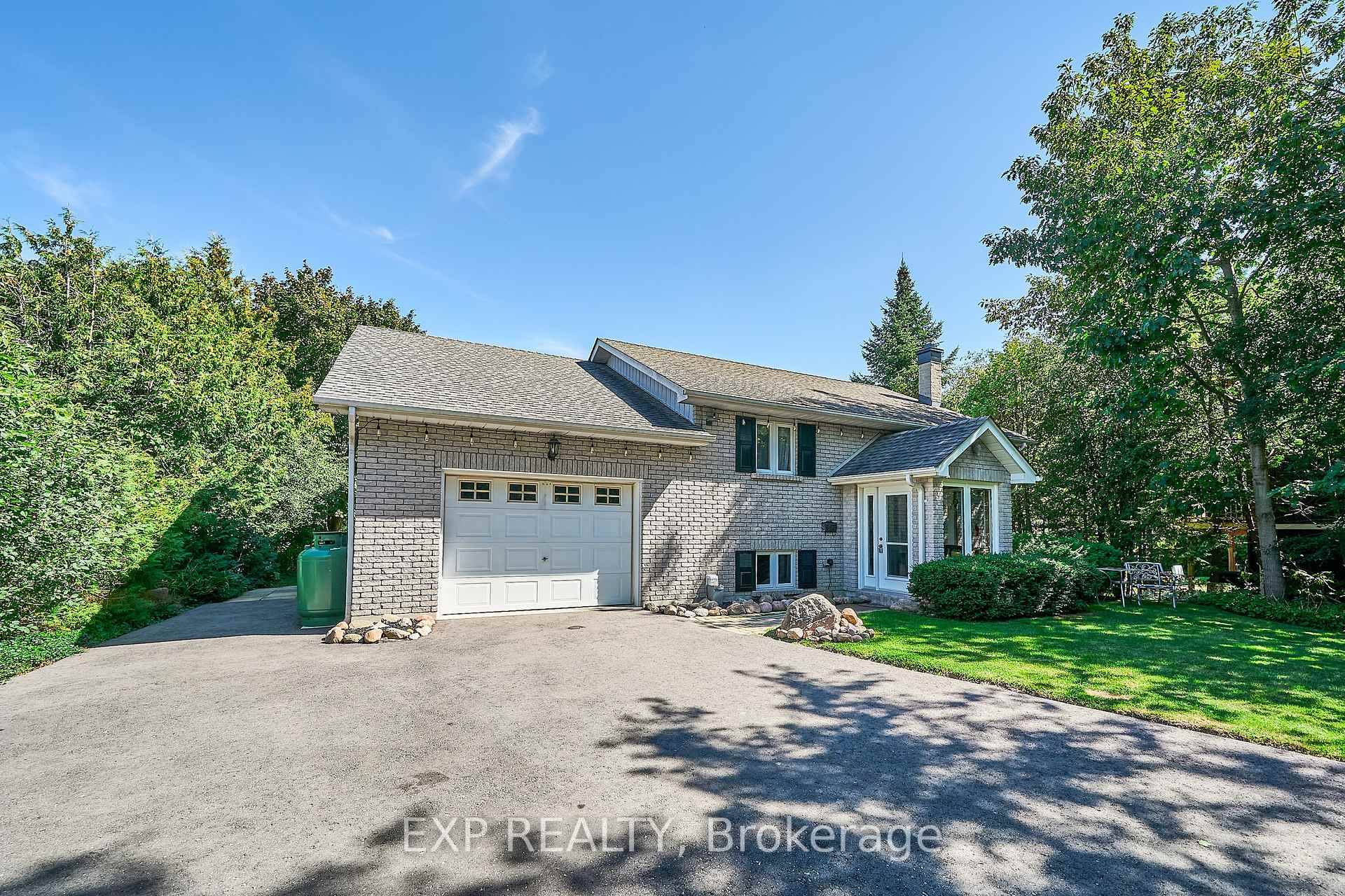 WATERFRONT Beautiful custom built All brick angle stone raised bungalow on a wide 89' private, manicured waterfront lot.