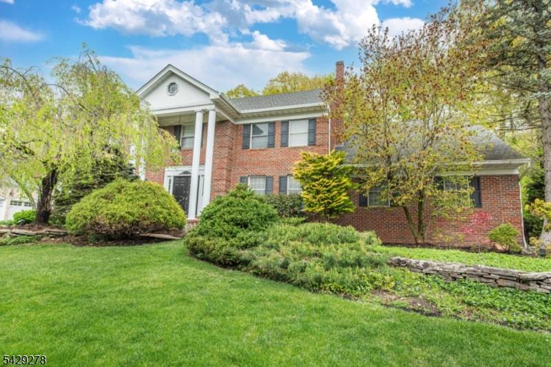 IMPRESSIVE 5 BR, 4. 2 BTH Center Hall Colonial with attached two car garage tucked away on one of the most desirable streets in North Caldwell !
