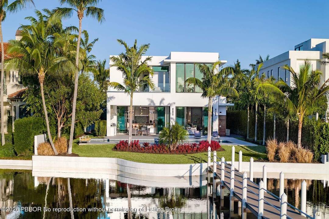 Experience refined, effortless living in this gorgeous waterfront estate nestled in the private enclave of Hypoluxo Island.