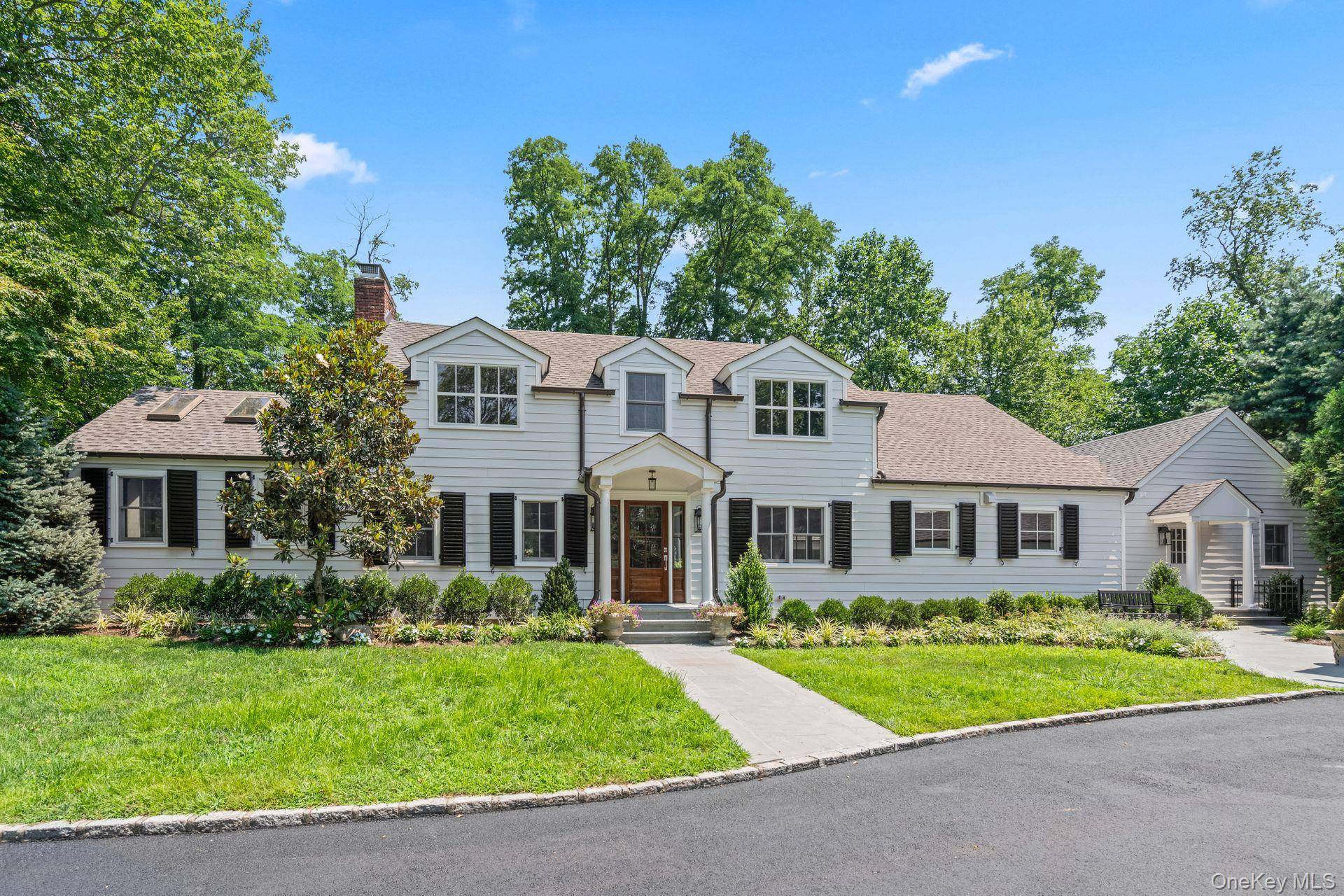 Tucked away on a private road in the Incorporated Village of Laurel Hollow, this newly renovated 1910 Colonial masterfully blends historic charm with modern luxury on 2.