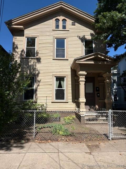 This wonderful three family is on a quiet one way street in the Wooster Square area.