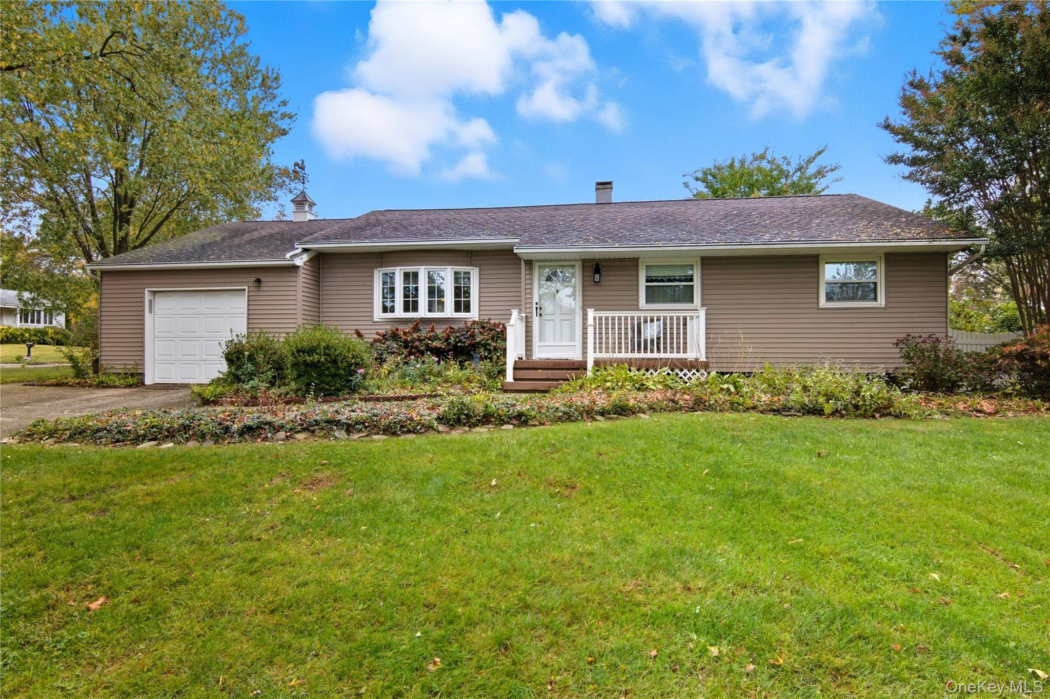 Welcome to this charming 3 bedroom, 2 full bath ranch set on a beautifully landscaped property just shy of half an acre in the highly sought after Northport School District.