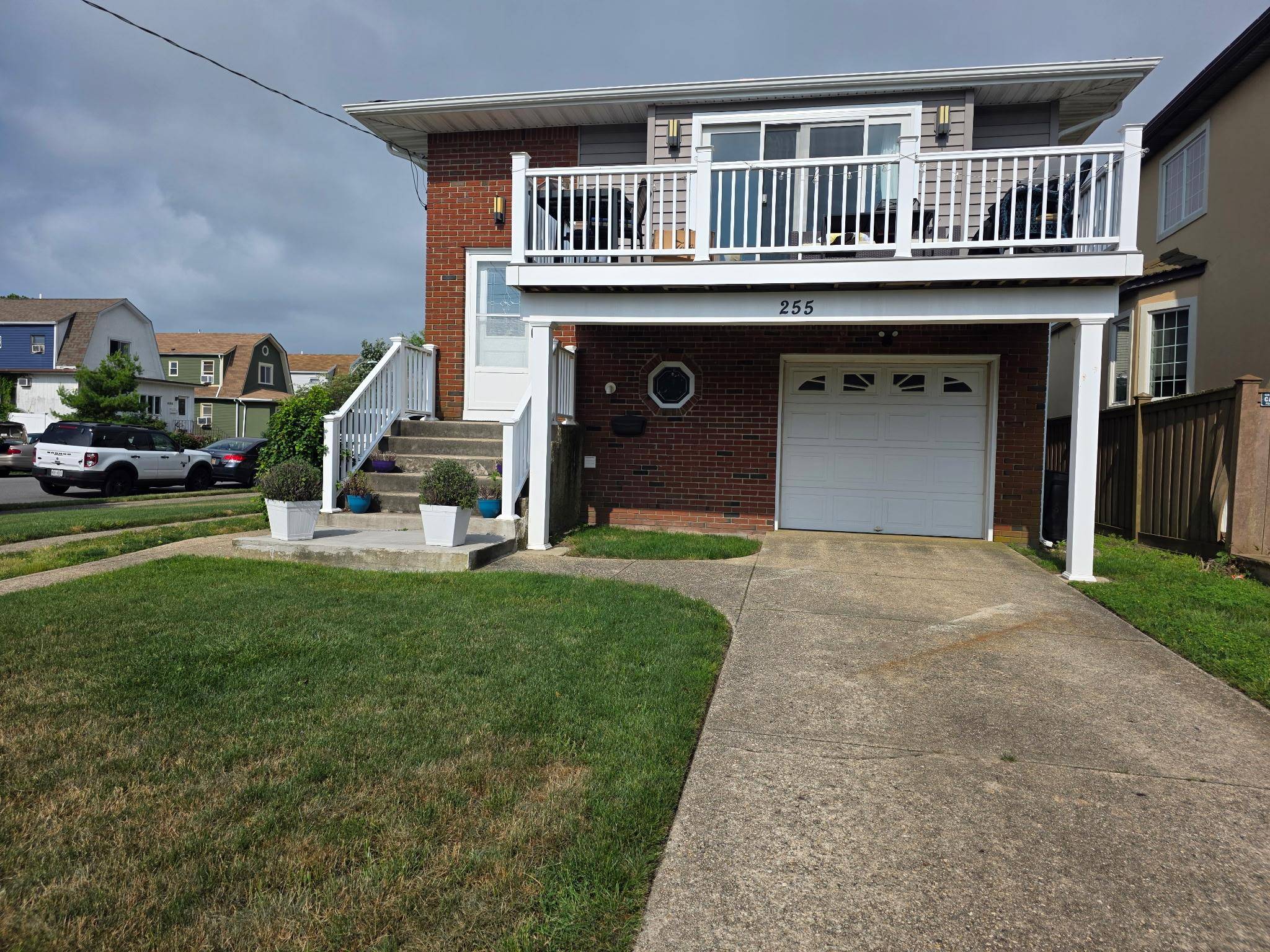 TOTALLY renovated, beachside, corner property featuring Living room with sliders to a deck with TREX decking and electric, dining area, EIK with stainless steel appliances, quartz countertops, built in microwave.
