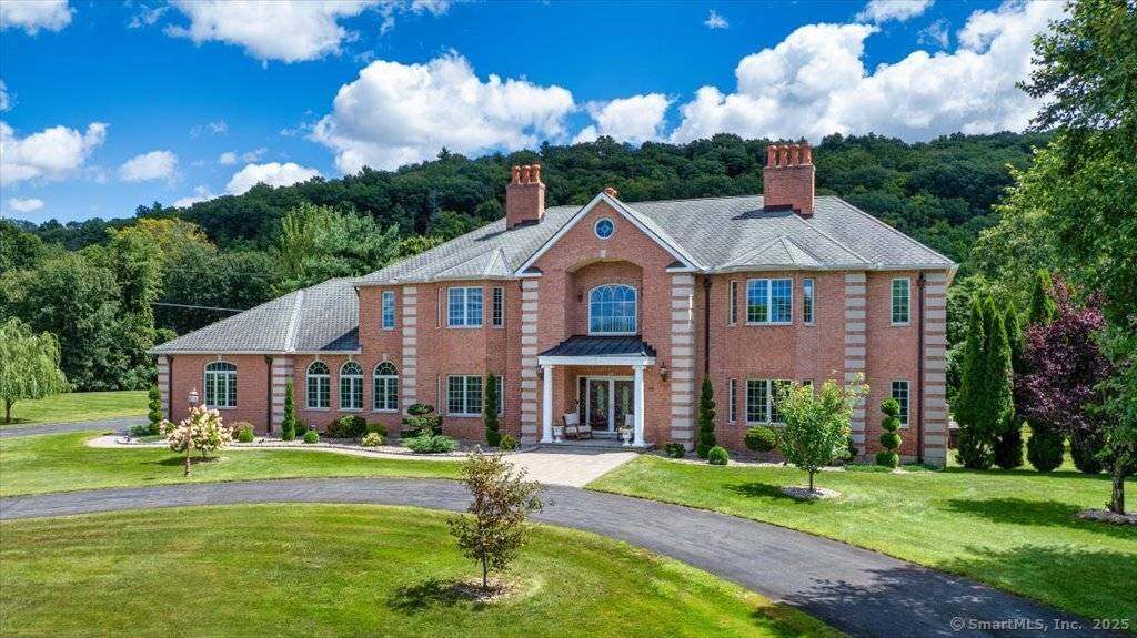 This stunning brick Colonial sits atop Hunting Ridge Drive on a sprawling two acre level lot, offering panoramic views of the Farmington Valley and breathtaking sunsets !