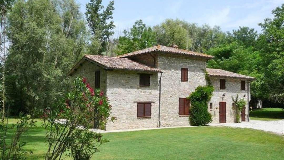 Lovely two-storey stone farmhouse with garden for sale near Perugia, in Umbria.
