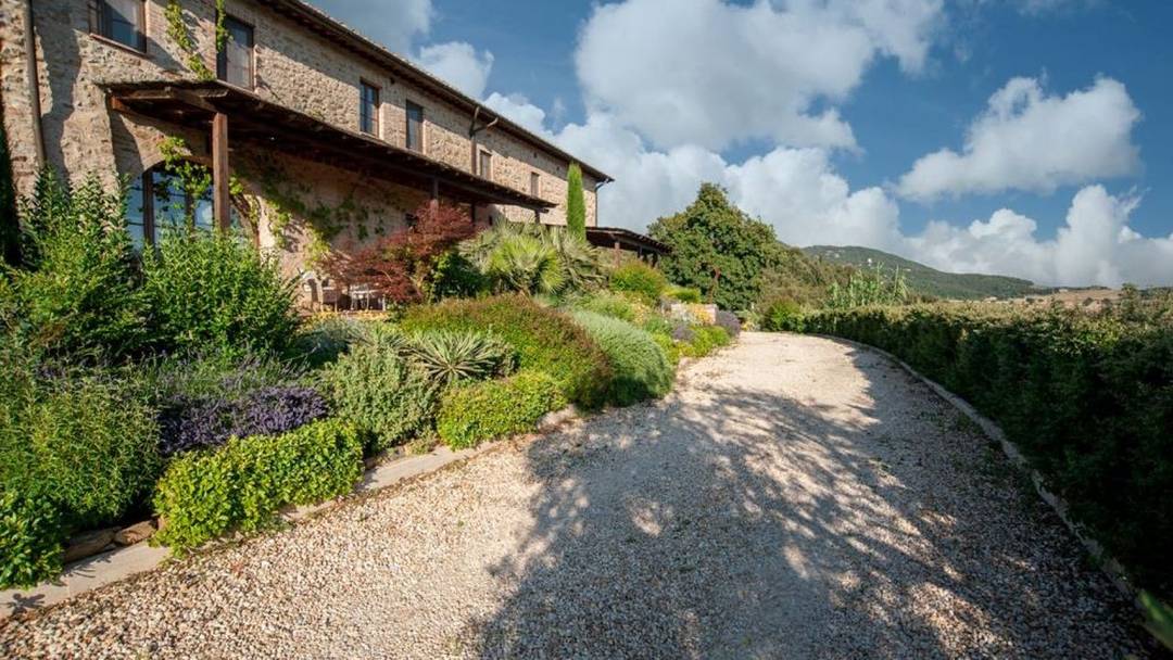Renovated 15th-century farmhouse with 10 hectares of land, 7 flats and swimming pool, for sale in the heart of Tuscany.