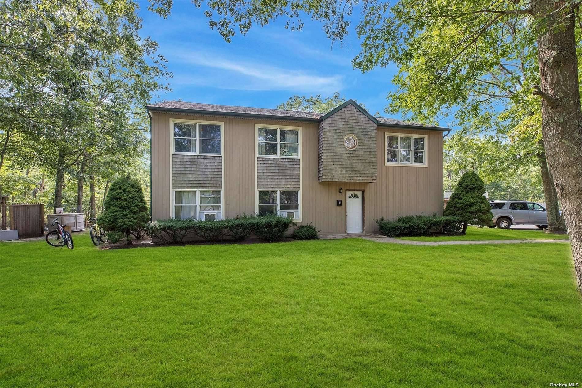 Raised ranch has six total bedrooms, three full baths, living room, dining room, two kitchens, oak floors, CAC, full deck.