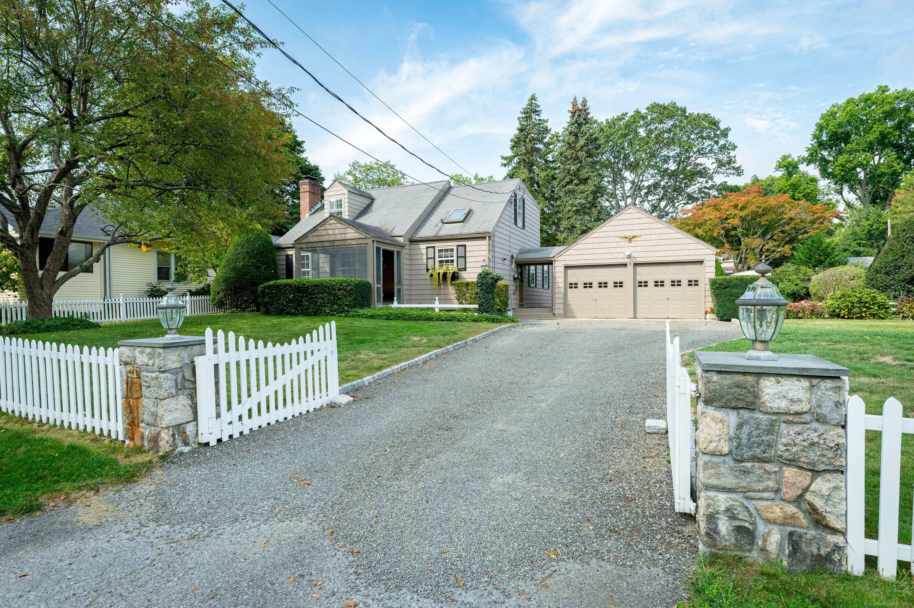 Eye catching curb appeal greets you from the white picket fence, stone pillars and Belgium block lined driveway accented by crushed stone.