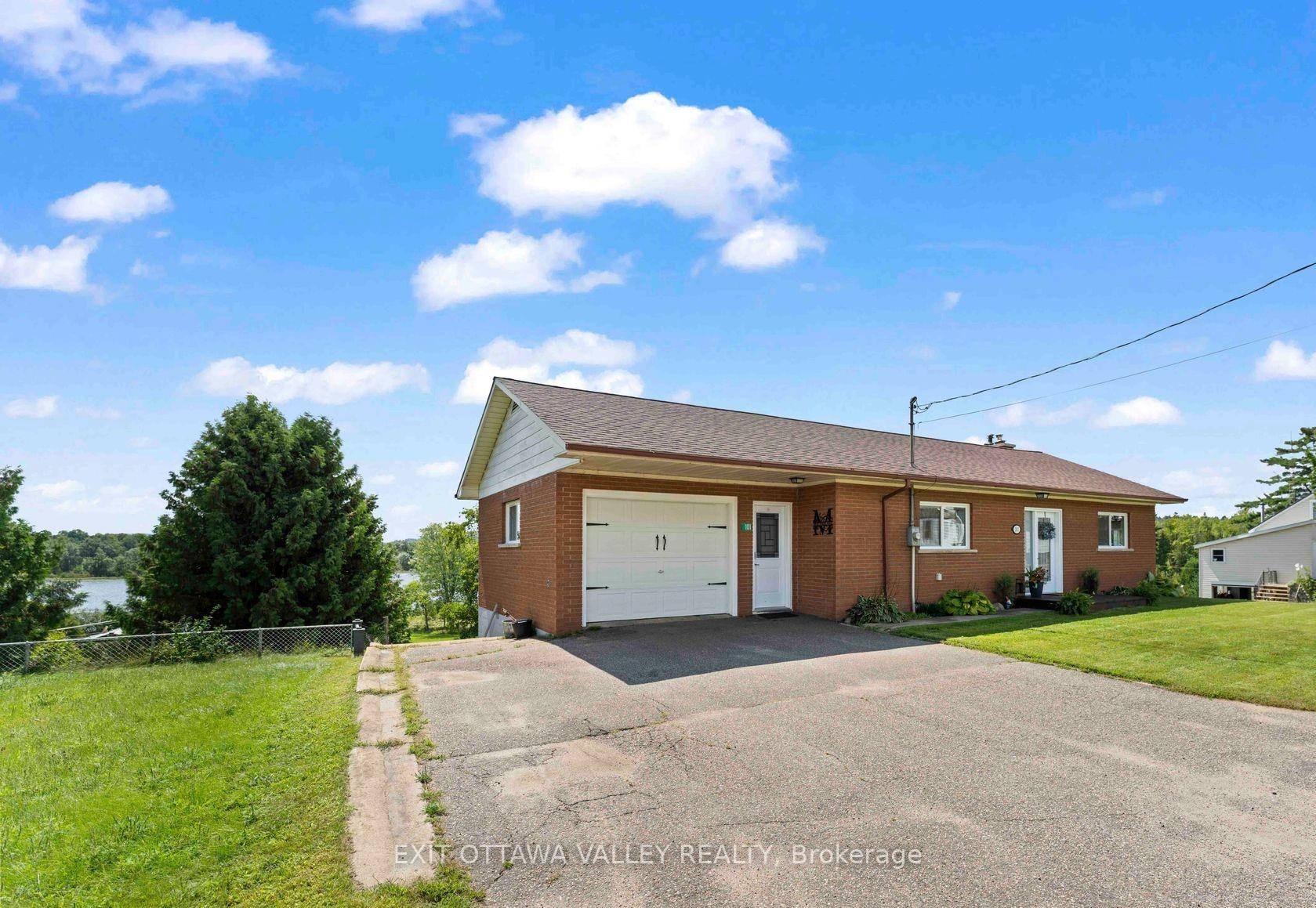 Discover the incredible potential of this solid brick bungalow, ideally situated on a full acre of prime waterfront along the scenic shores of Kamaniskeg Lake.