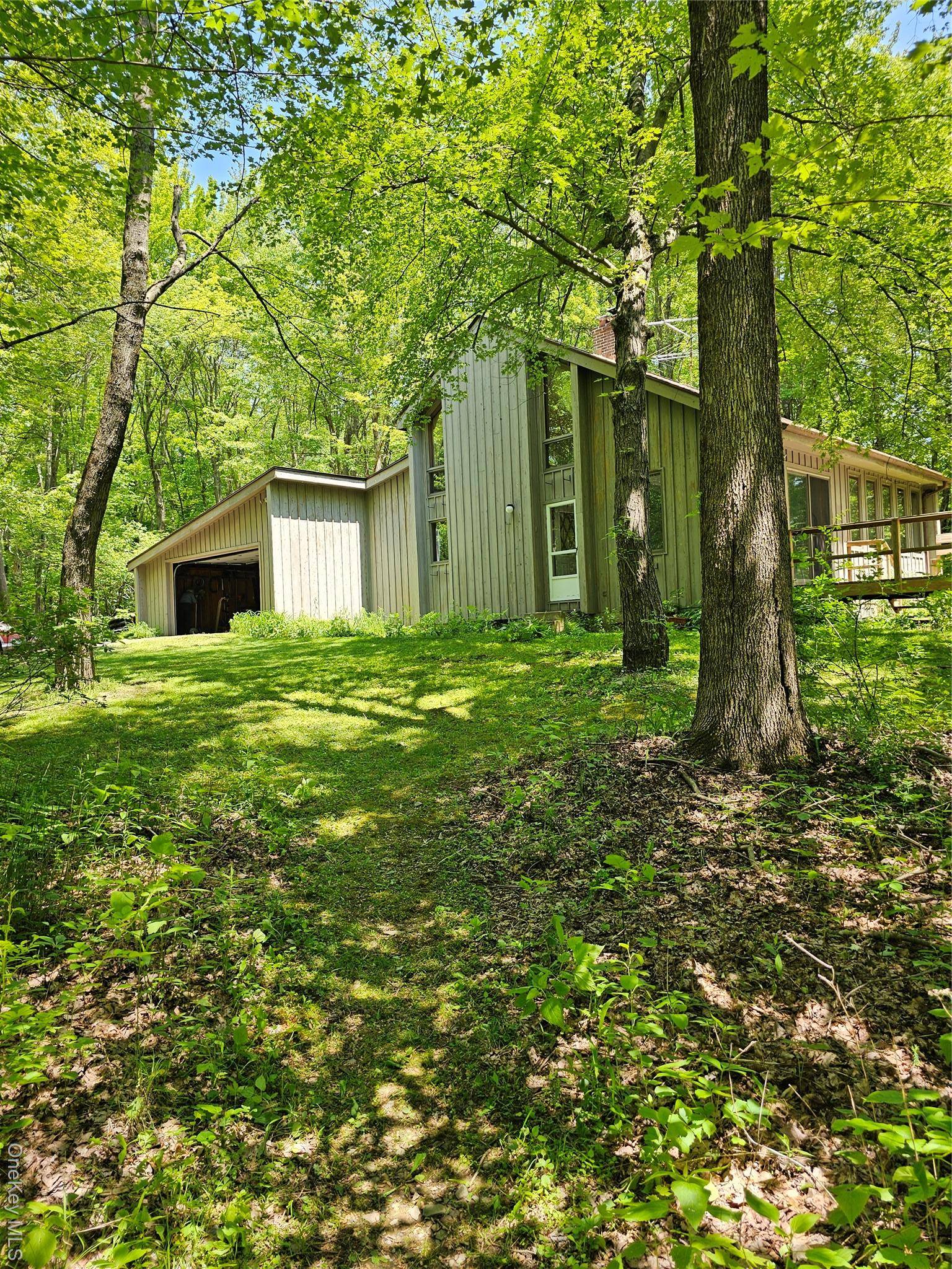 Welcome to your private retreat, complete with 5 acres of nature ; with a new improved price !