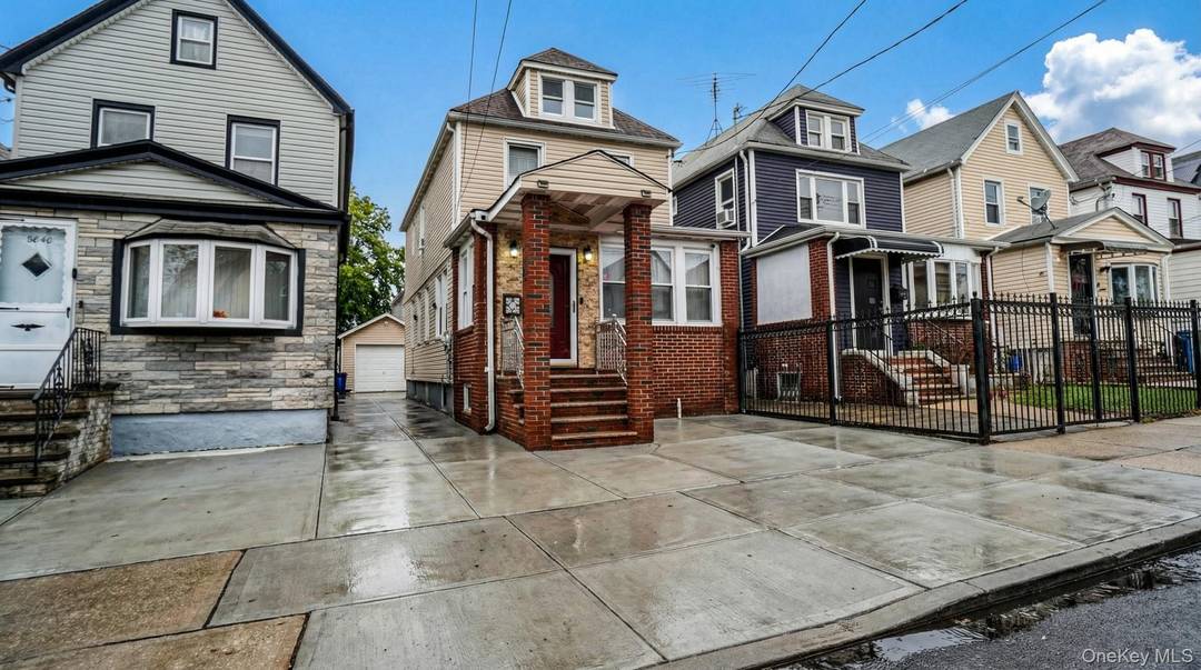 Updated single family with private driveway, garage, finished attic, and full finished basement with separate entrance in prime Hollis location.