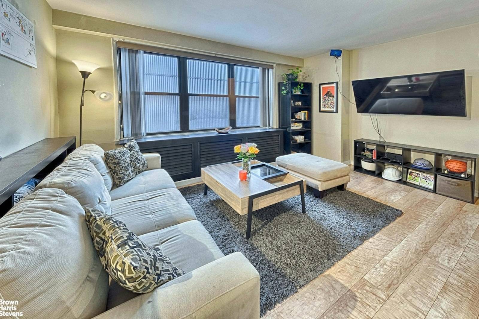 Peaceful bright renovated oversized alcove studio already converted into a junior one bedroom with separate sleeping area off the living room.