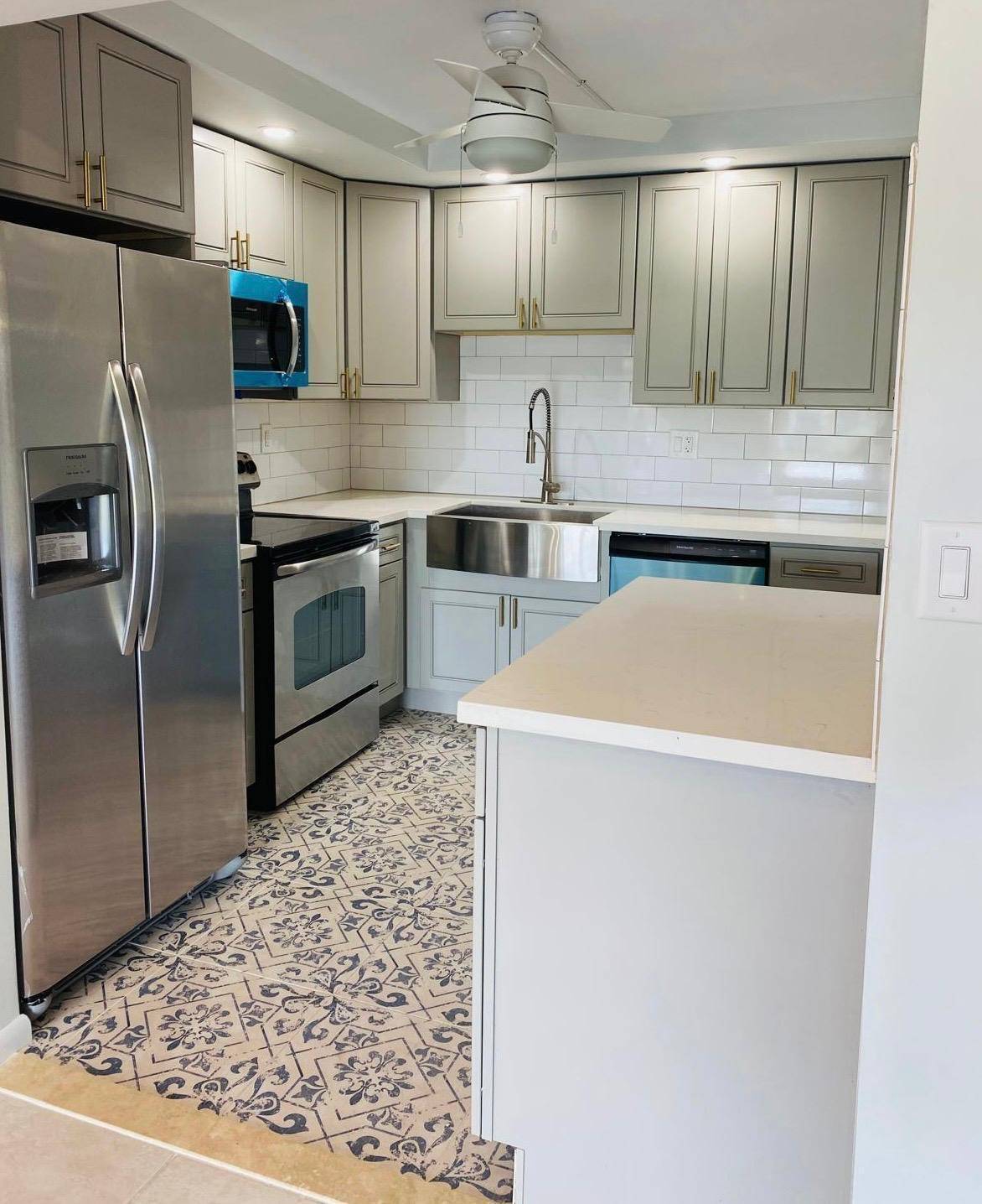 This beautifully remodeled corner unit offers serene views of the Boca Dunes Golf Course and the community pool.