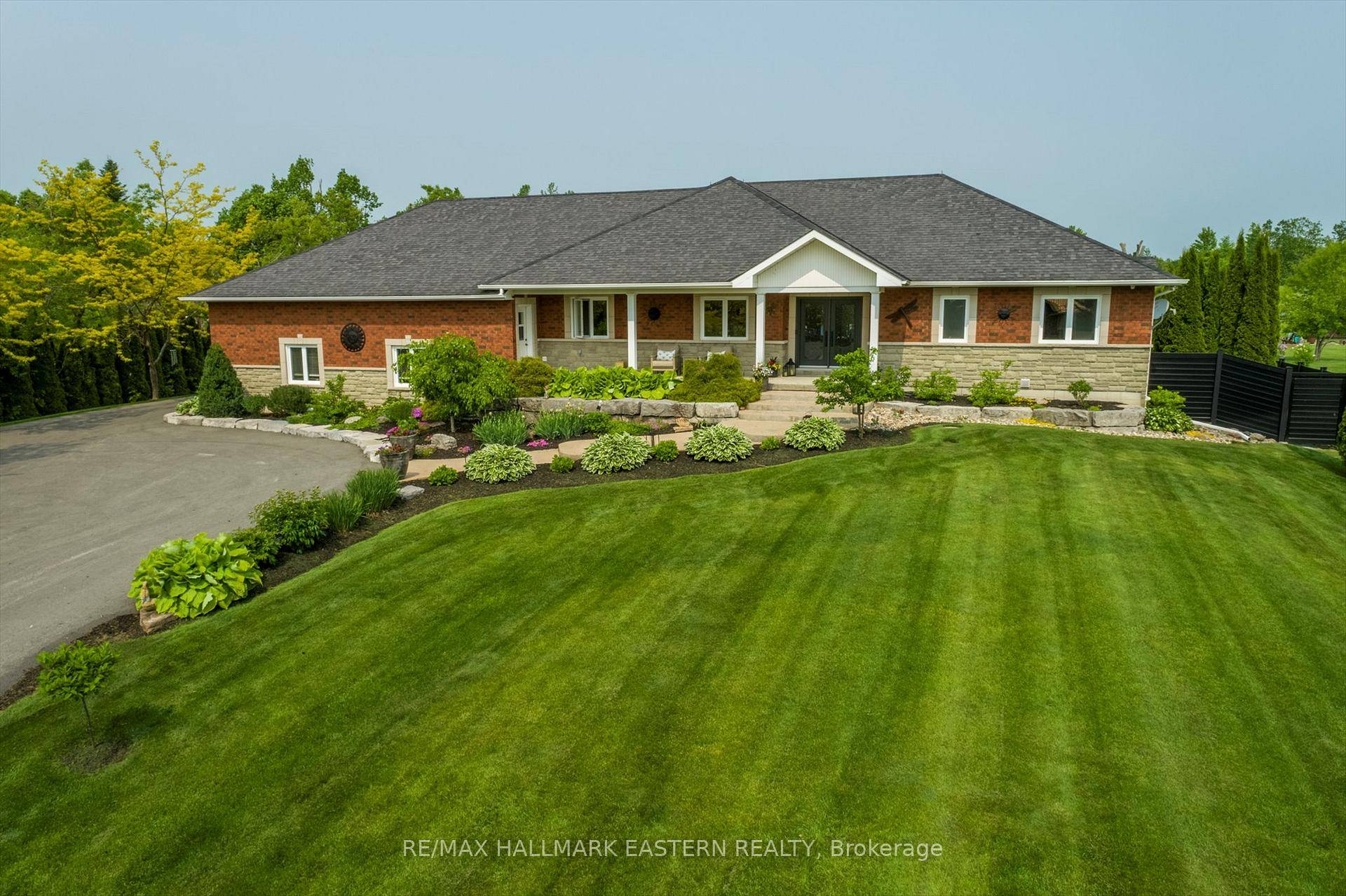 With over 4000 sq ft of finished living space, this luxury bungalow offers deeded water access to Pigeon Lake, a dock, and 2.