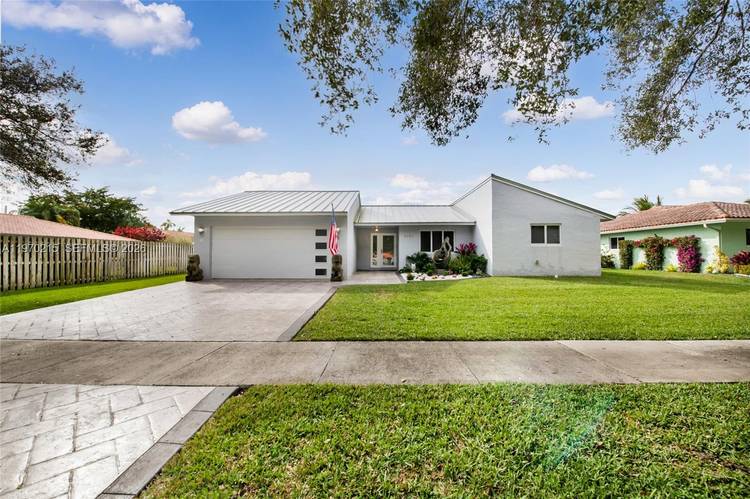 Welcome to this stunning lakefront home in the highly sought after Forest Lake community of Cooper City.