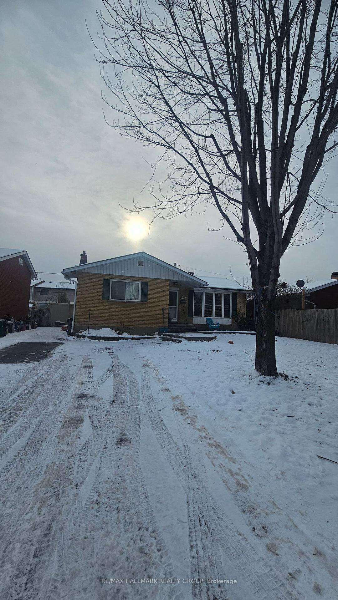 Beautiful 5 bedroom brick bungalow in Castle Heights featuring hardwood floors, a solid oak kitchen, fenced yard, large shed, and a fully finished basement with separate entrance.