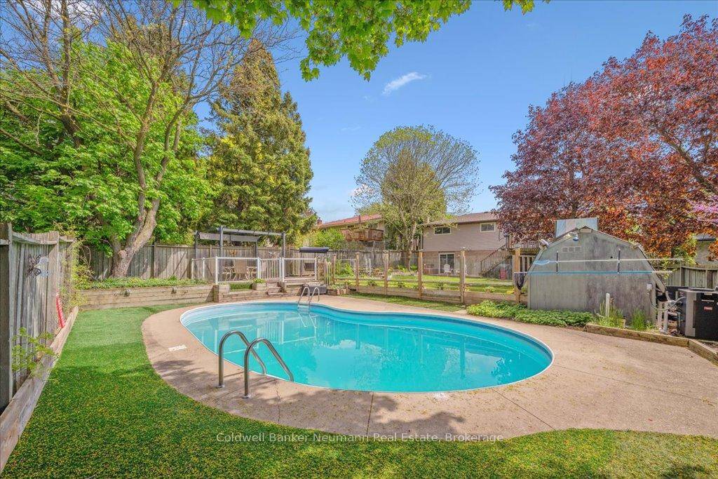 Welcome to 31 Carey Crescent, a beautifully maintained raised bungalow offering 3 bedrooms, 2 full bathrooms, a finished walkout basement, and a heated in ground pool.