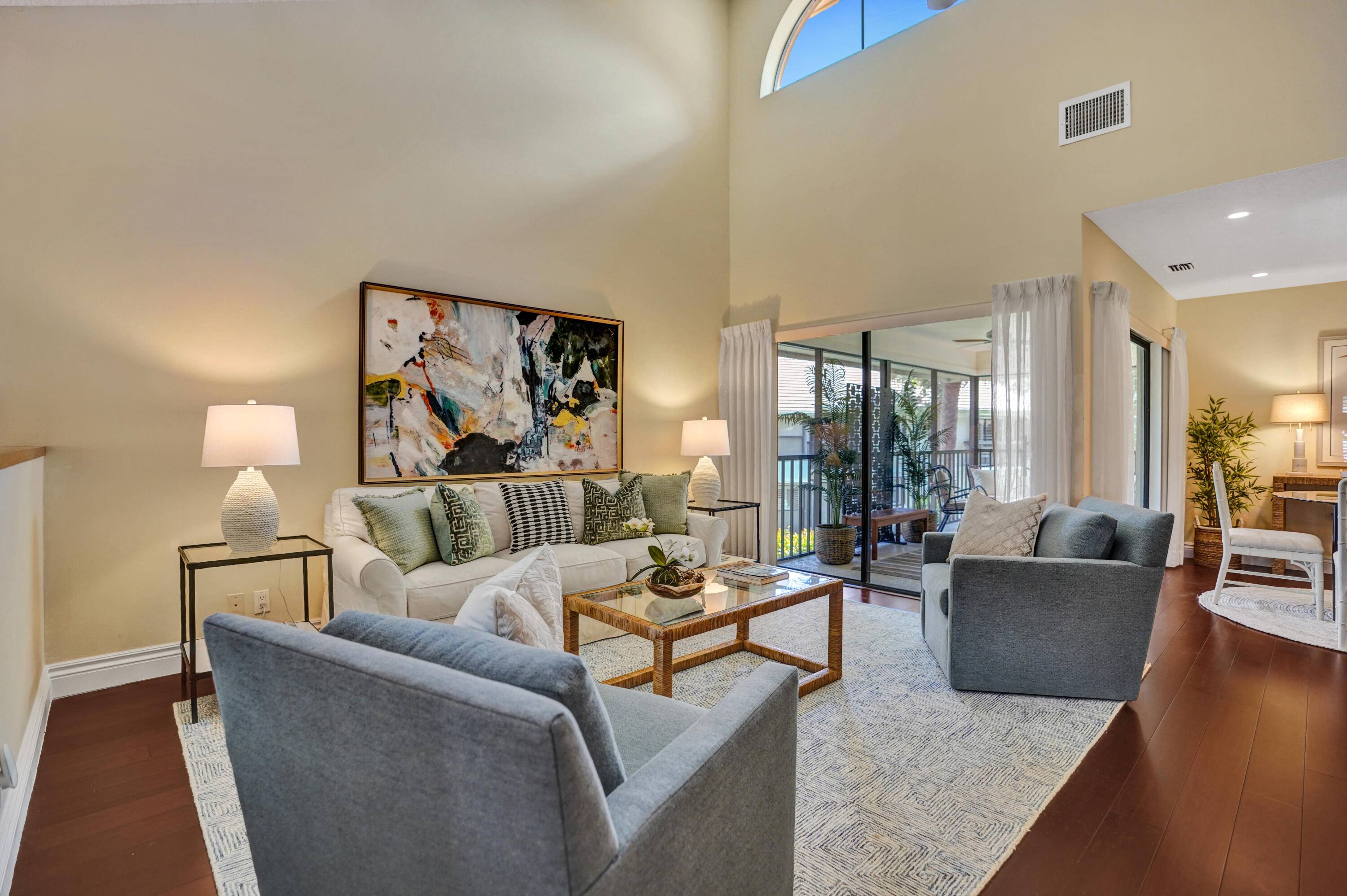 Enjoy tranquil water views lush gardens from this beautifully appointed home featuring a newly installed elevator, rich hardwood floors, plantation shutters vaulted ceilings.