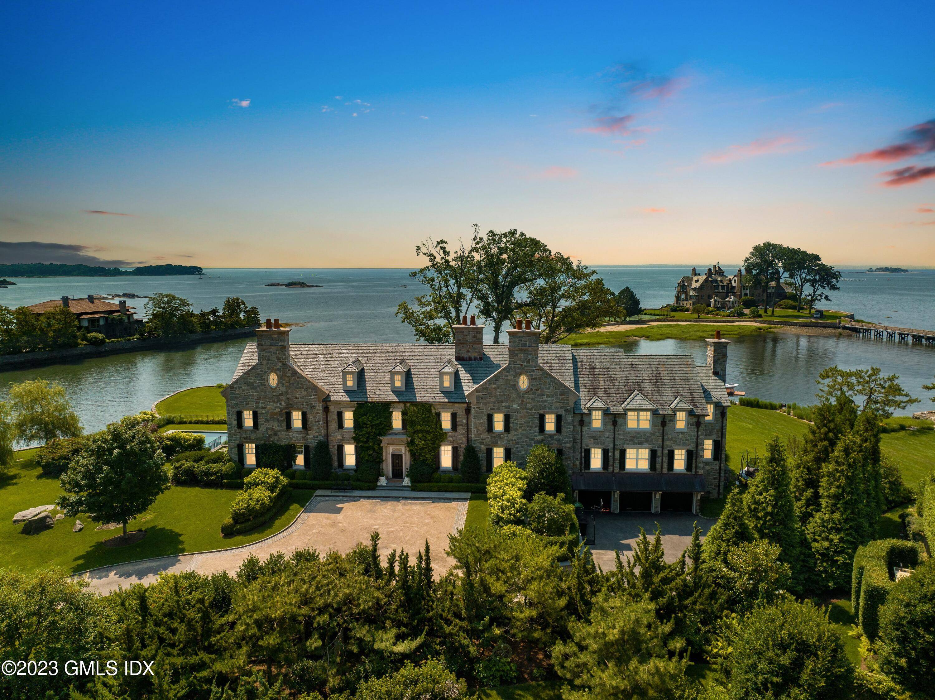 An idyllic coastal respite, this distinguished stone Georgian Colonial is direct waterfront with views of the Long Island Sound in the private Mead Point Association with 24hr guard gated security.