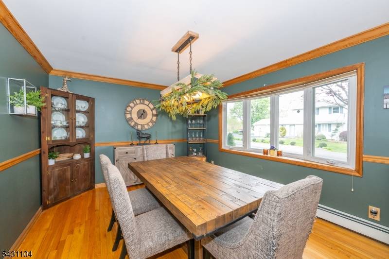 Spacious, light filled, Colonial on a level lot with a fenced backyard bordered by lush tree hedges for privacy.