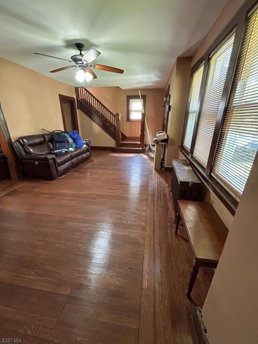 Charming 3BR, 1BA home featuring a large living room, dining area, spacious kitchen, beautiful hardwood floors, and a huge backyard perfect for relaxing or entertaining.