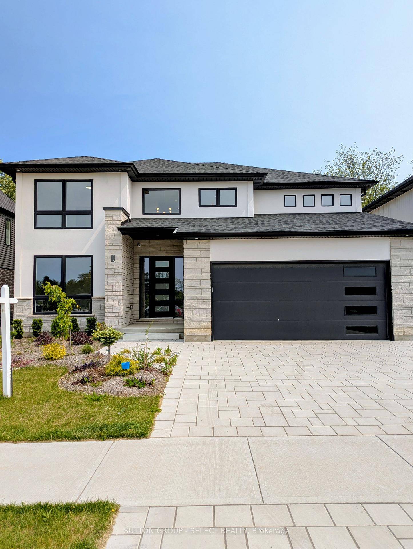 This two storey executive home displays impressive curb appeal with natural stone, brick, and stucco combined with enlarged windows and front door with side lights, and a large covered outdoor ...