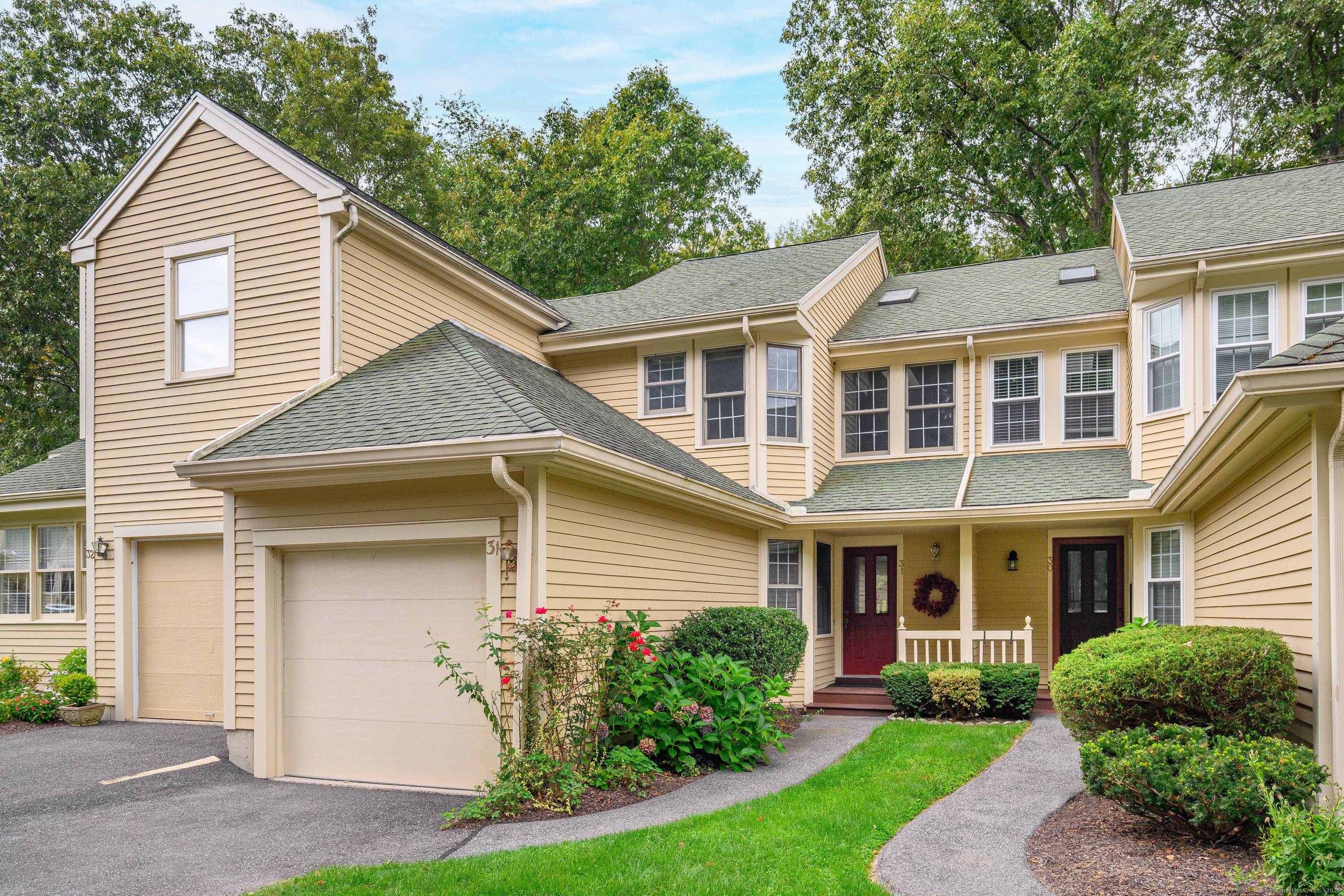 Sought after Sullivan Farm townhome nestled in the woods on a quiet cul de sac with rights to Candlewood Lake.