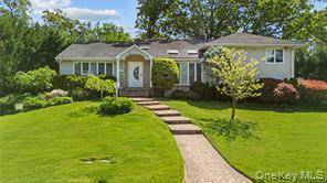 This stunning split level home features a spacious eat in kitchen with custom cabinetry, granite countertops, and state of the art appliances.