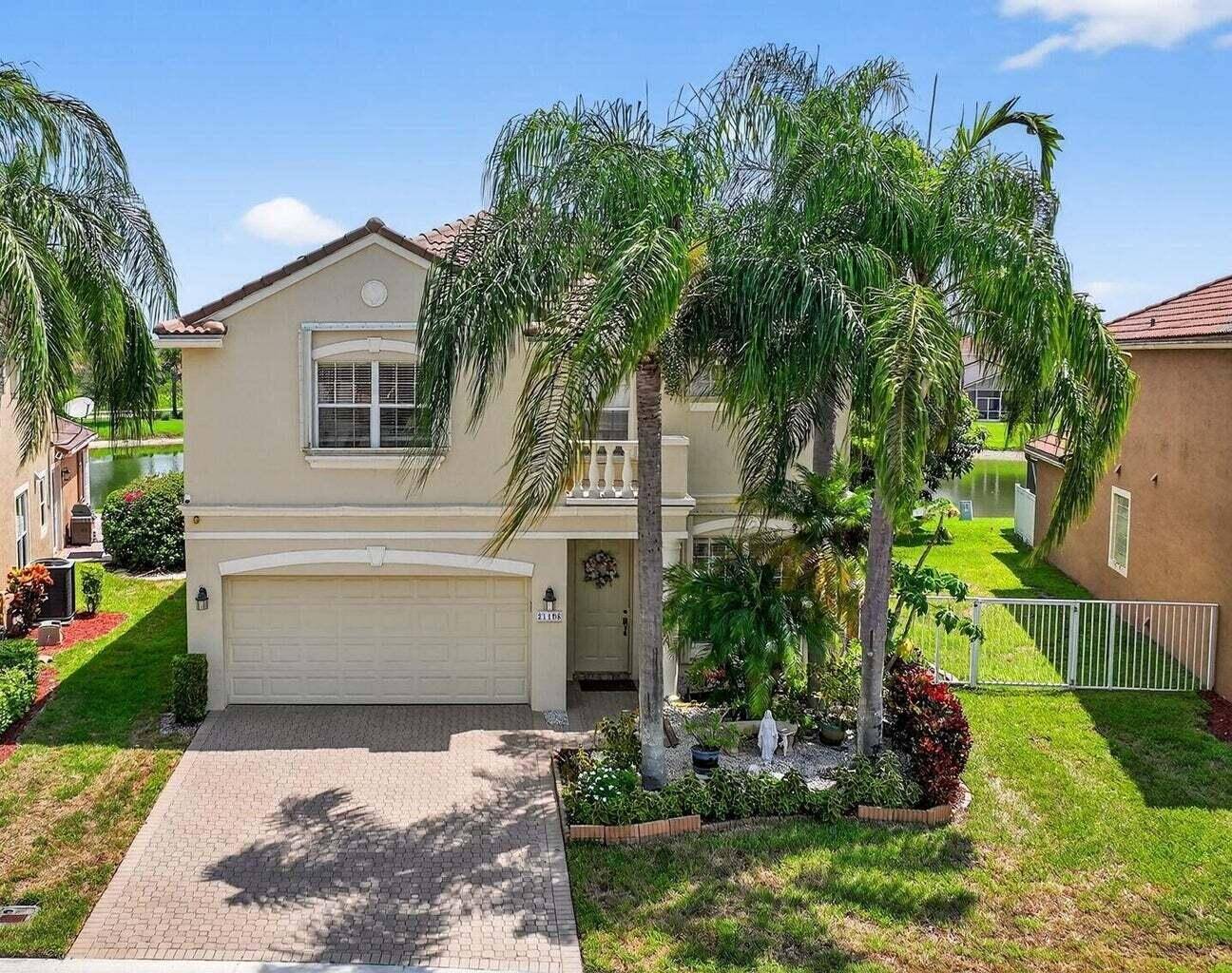 Welcome to 21196 Via Ventura, a rare lakefront estate in Boca Raton's desirable man gated community of Mizner Pointe.