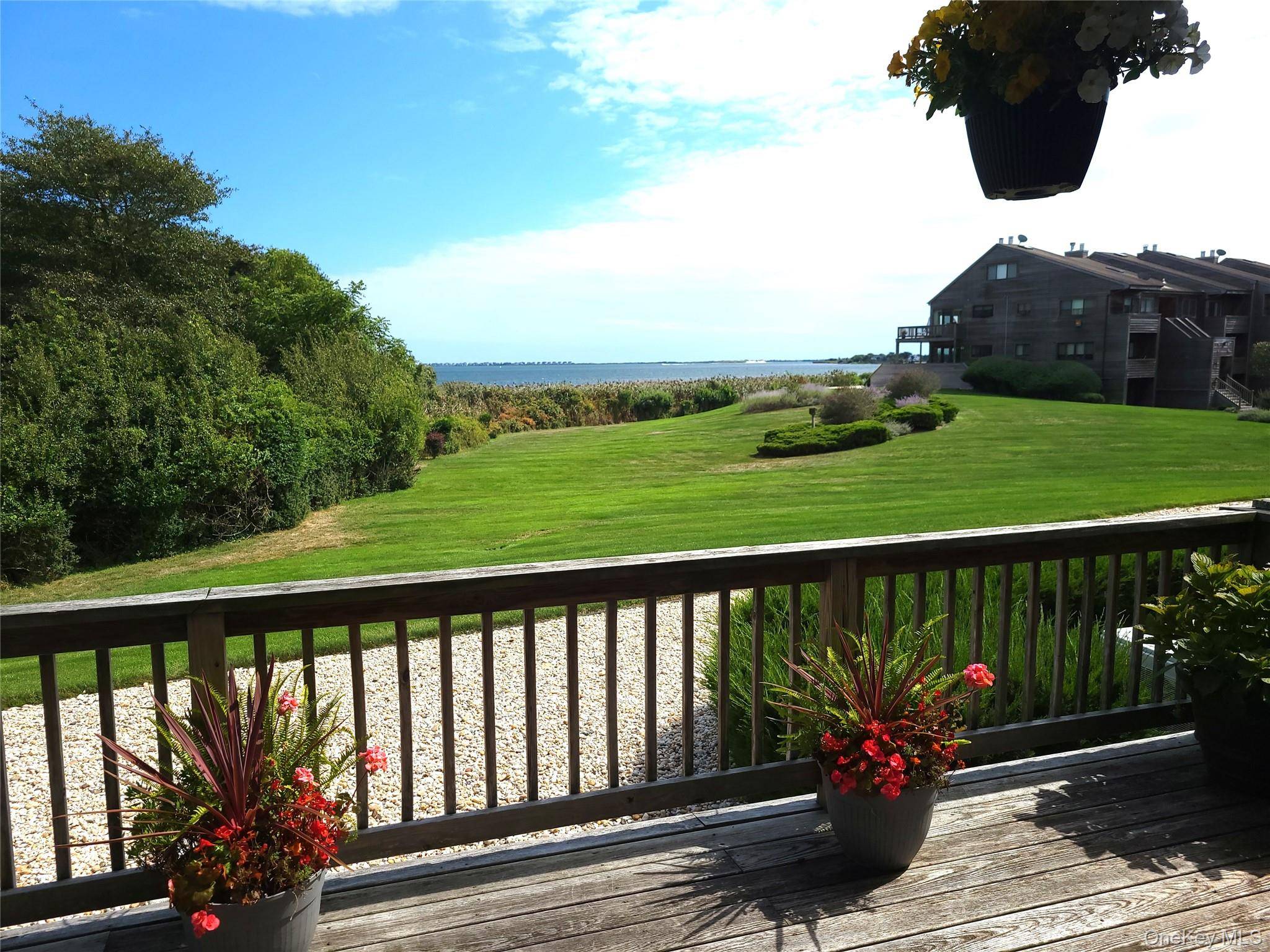 Waterfront End Unit featuring a Wraparound Deck located on Harts Cove with views of Moriches Bay and the Westhampton Dunes area of Dune Road.
