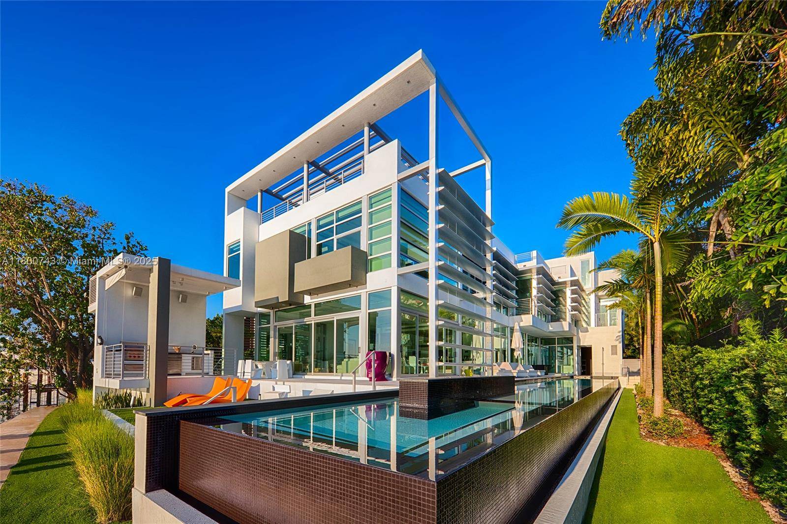 Modern tri level waterfront home located on the coveted tip of guard gated Hibiscus Island.
