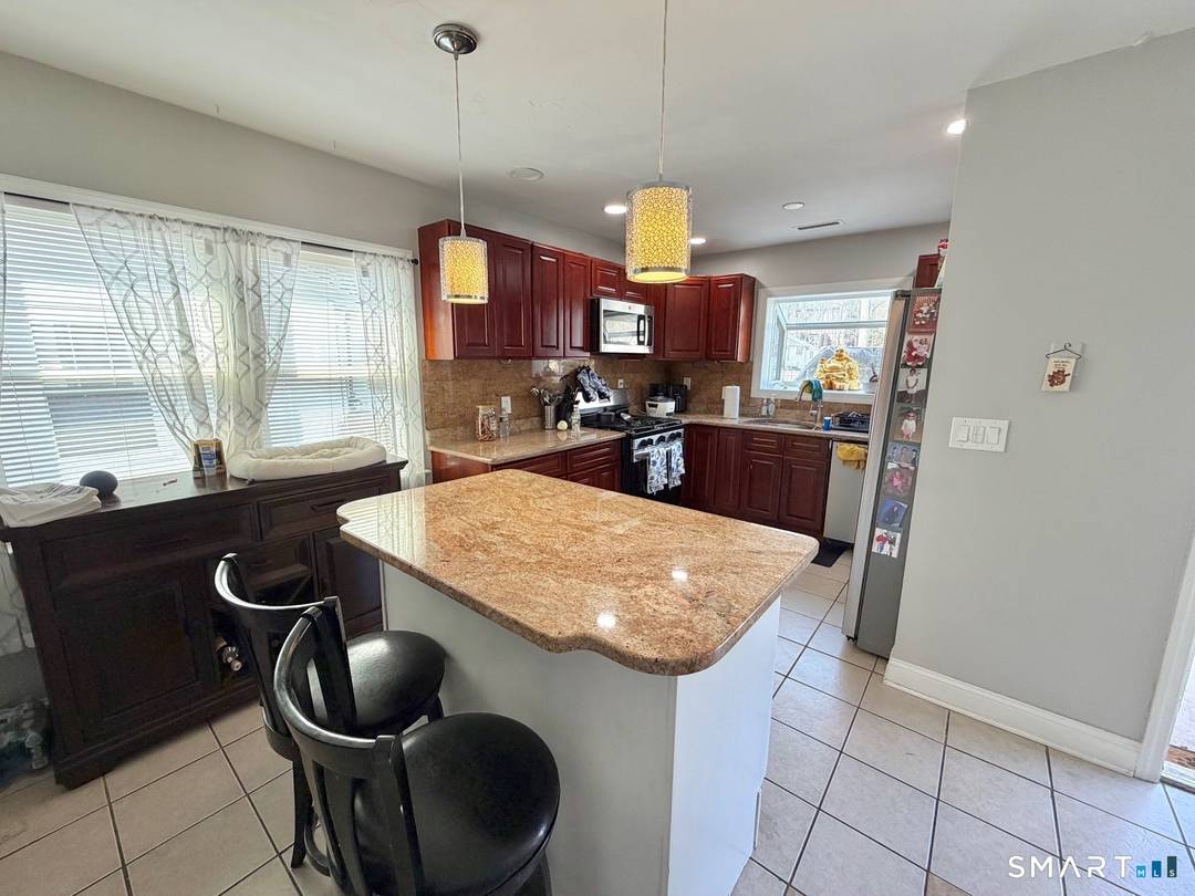 Welcome to this modern ranch home in Stamford's desirable Newfield neighborhood, offering the perfect blend of comfort, versatility, and charm.