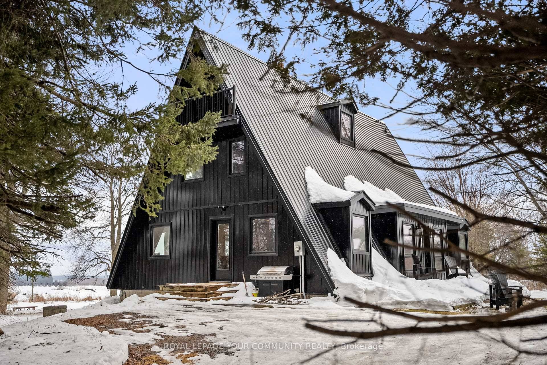 One of a Kind Retreat Tucked away on private acreage ; this stunning black A frame is the epitome of luxury meets cozy simply bursting with rustic charm.