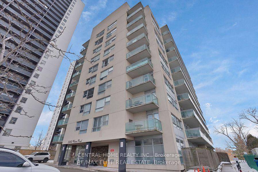 spacious open concept kitchen and living room with ceiling to floor windows.