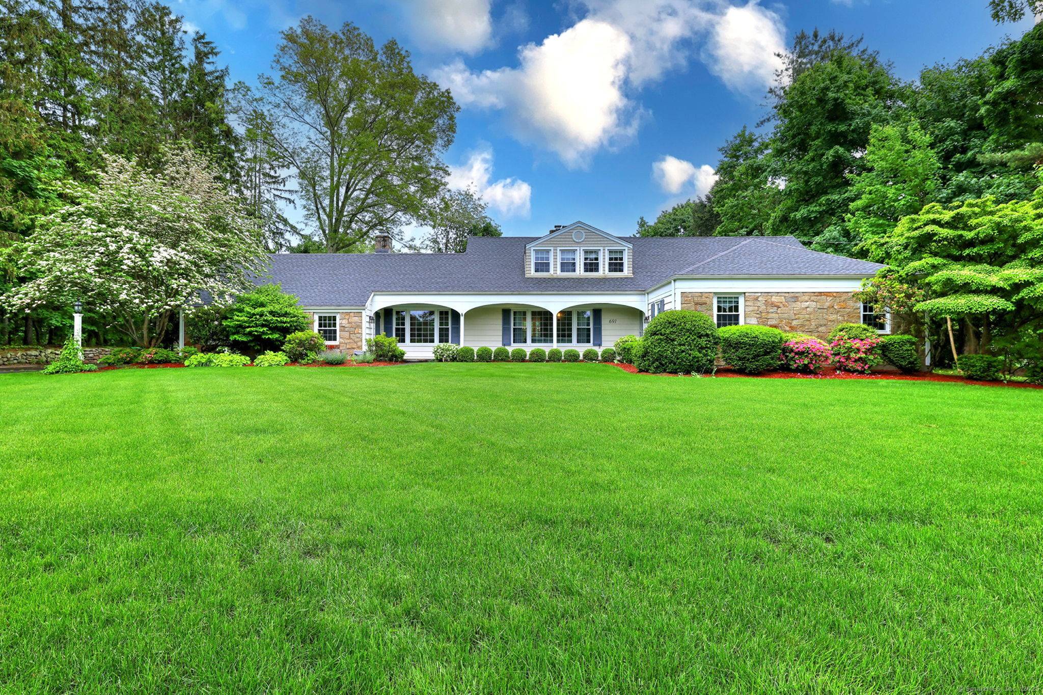 Welcome to this beautifully remodeled expanded Cape Cod style home situated on a spacious 0.