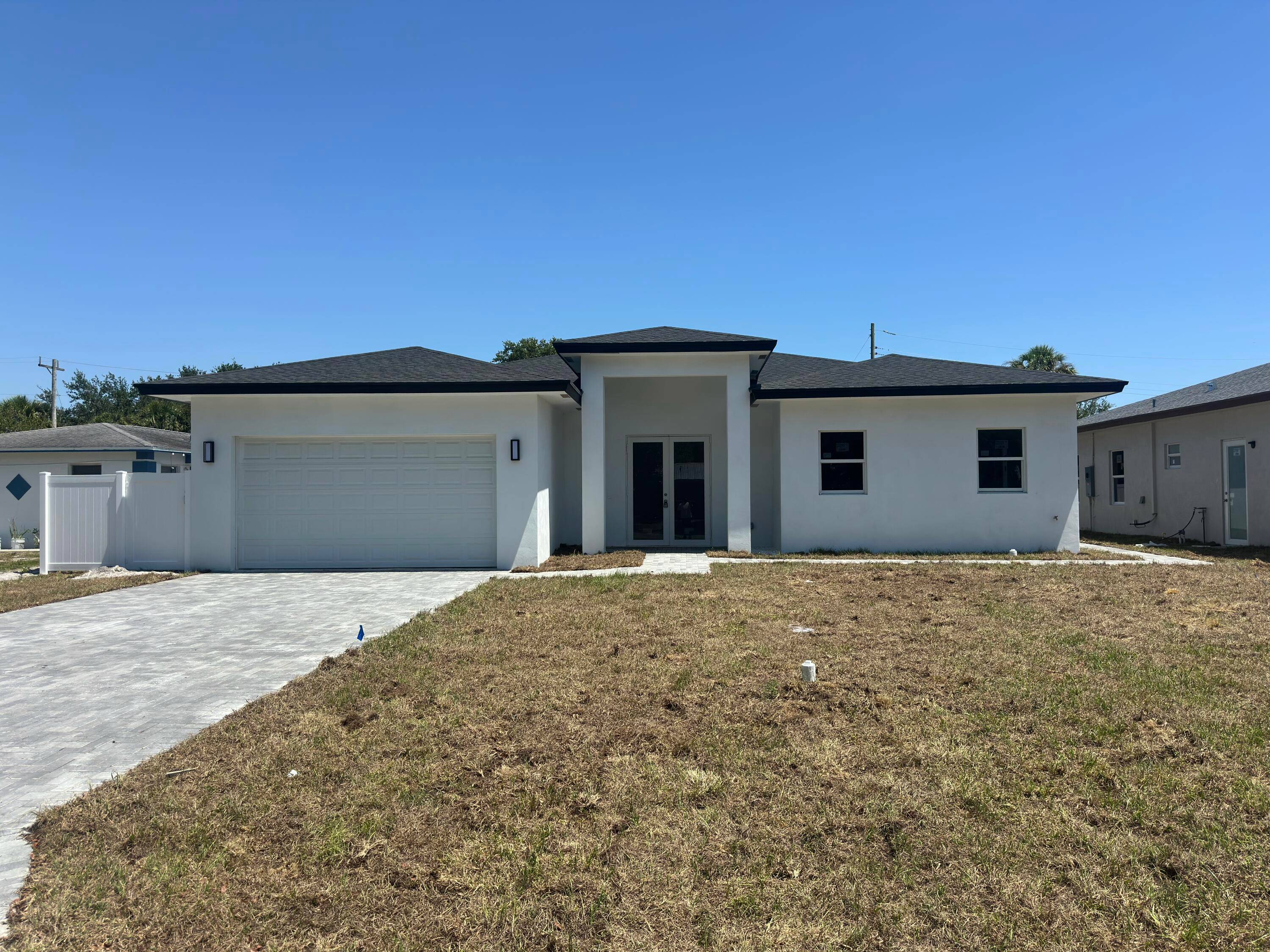 Modern 4 bed, 3 bath home featuring a sleek open kitchen with waterfall island, stainless steel appliances, and custom cabinetry.