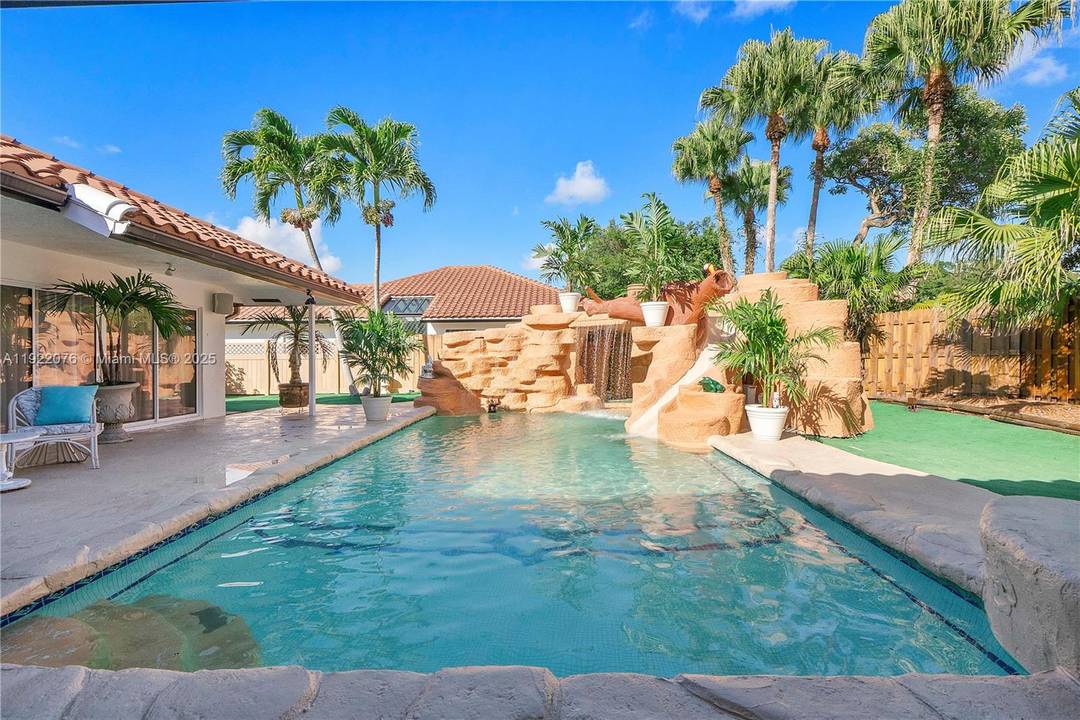 CORNER LOT ! ! ! Exciting Resort style Water Park back yard with an amazing water slide, and huge incredible water falls, that cascade down a two beautiful rock walls.