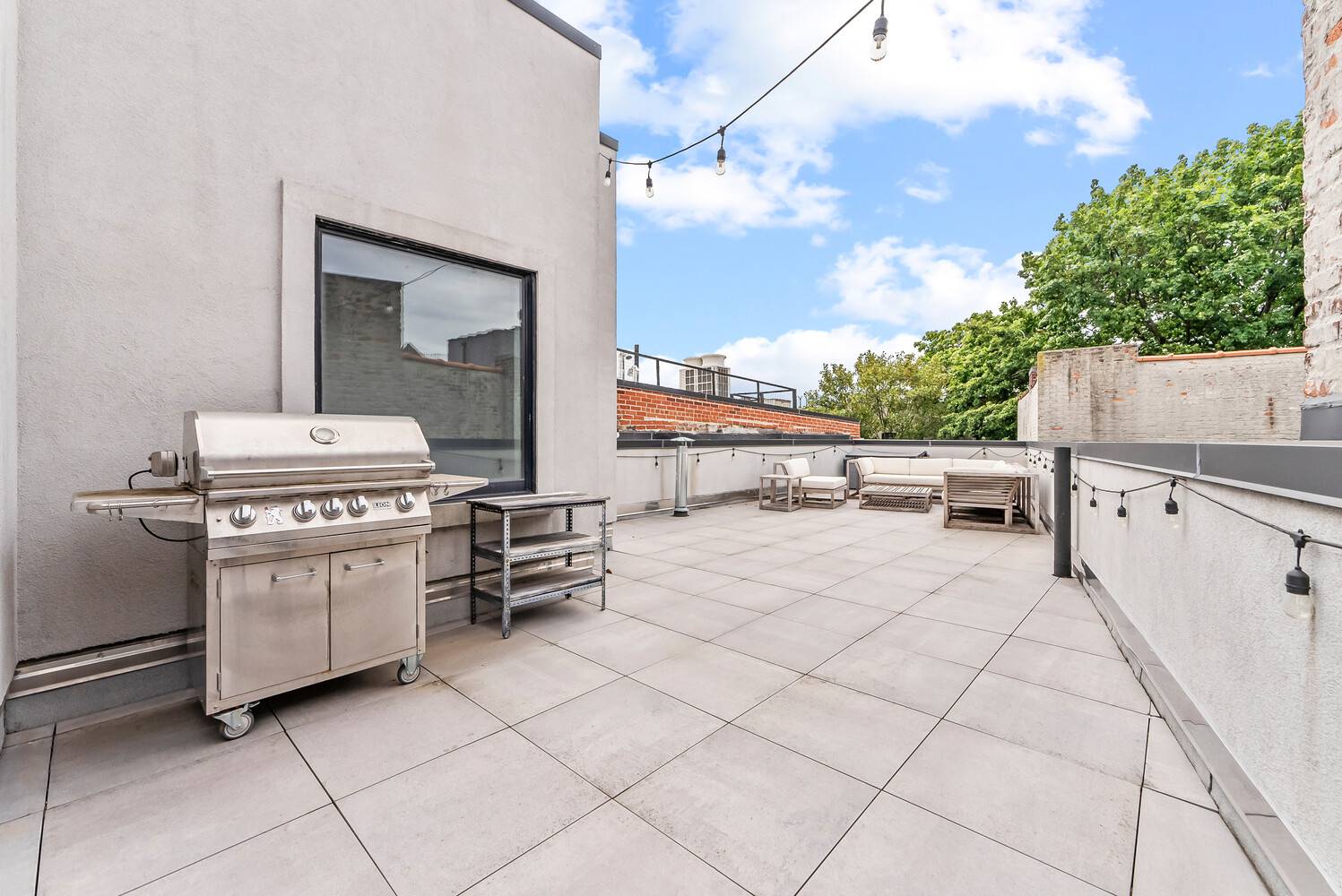 Welcome to this stunning full floor, three bedroom two bath duplex, crowned with an unmatched private rooftop spanning the entire building.