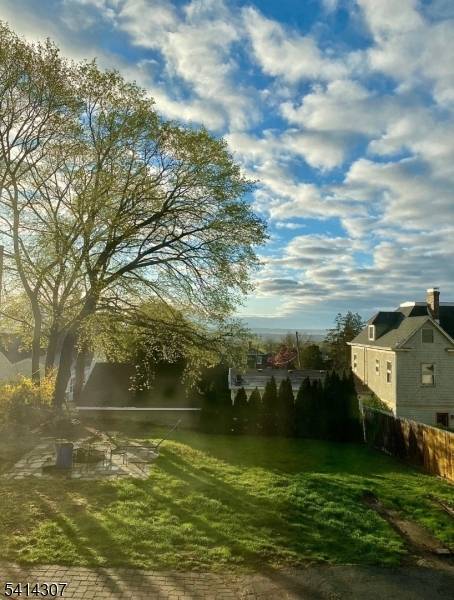 this Duplex has so much to offer large rooms lots of space and storage, hardwood floors, updated kitchens, front closed in porch, fireplace, off street parking, nice views, new roof ...