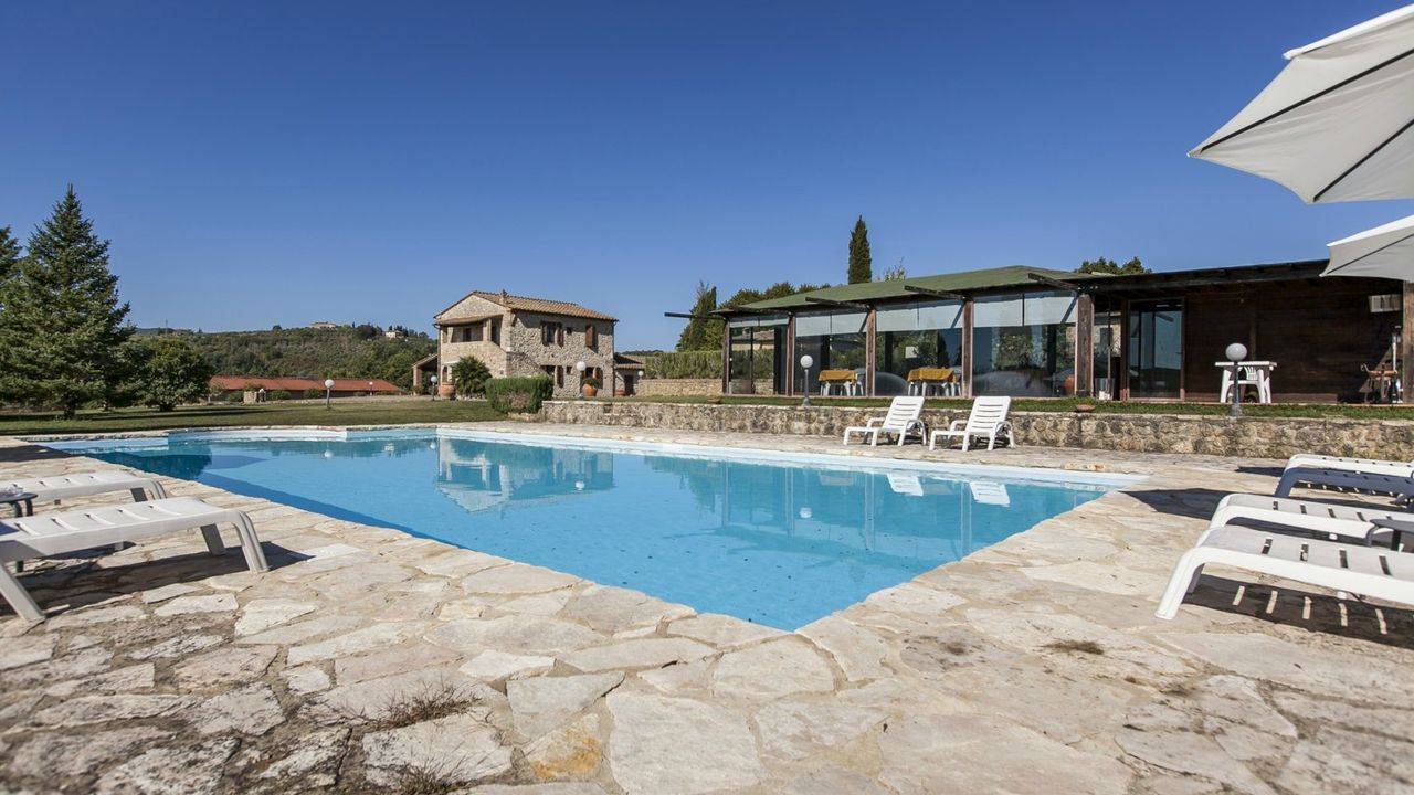In the Chianti hills, Tuscany area renowned for its precious wines, is on sale this farmhouse with vineyard, winery, farm and pool.