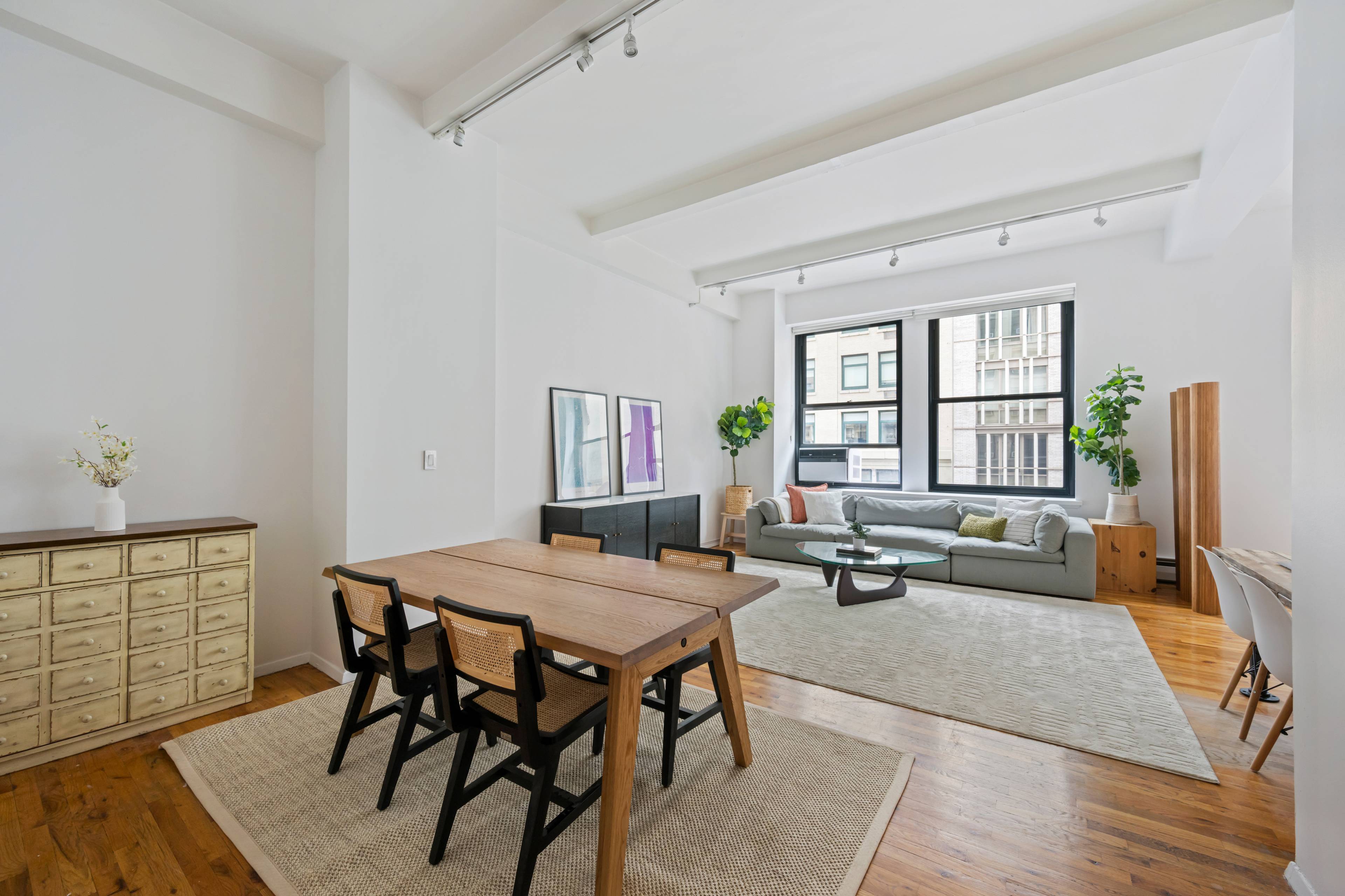 Enjoy true open loft living in this former factory building, defined by nearly 12 foot ceilings and an expansive wall of four towering 7 foot tall windows, granting you a ...