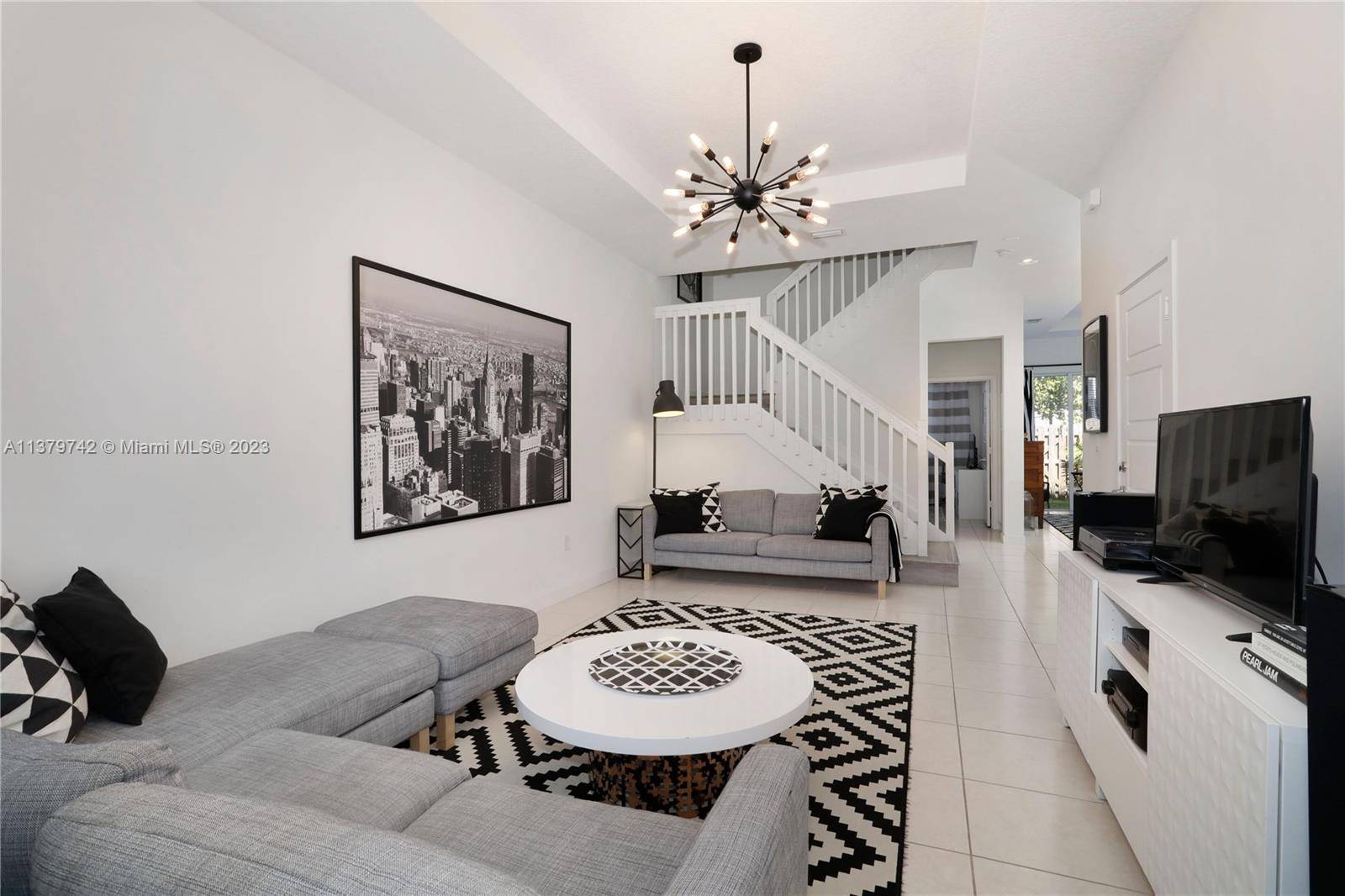 Spectacular four bedroom three bath contemporary townhome within Mosaic at Venetian Parc Community.